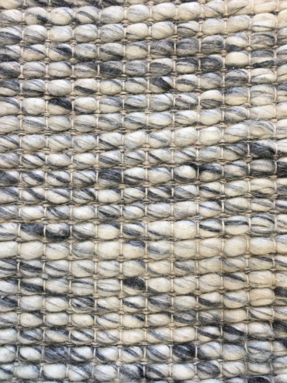 Dasha Grey is a texture hand woven rug made of 80%  New Zealand Wool and 20% Polyester. Colour Grey. Sizes 155 X 225, 200 X 290, 240 X 320 and 300 X 400. Close.