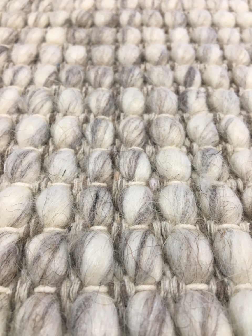 Dasha Light Grey is a texture hand woven rug made of 80%  New Zealand Wool and 20% Polyester. Colour Light Grey. Sizes 155 X 225, 200 X 290, 240 X 320 and 300 X 400. Angle.