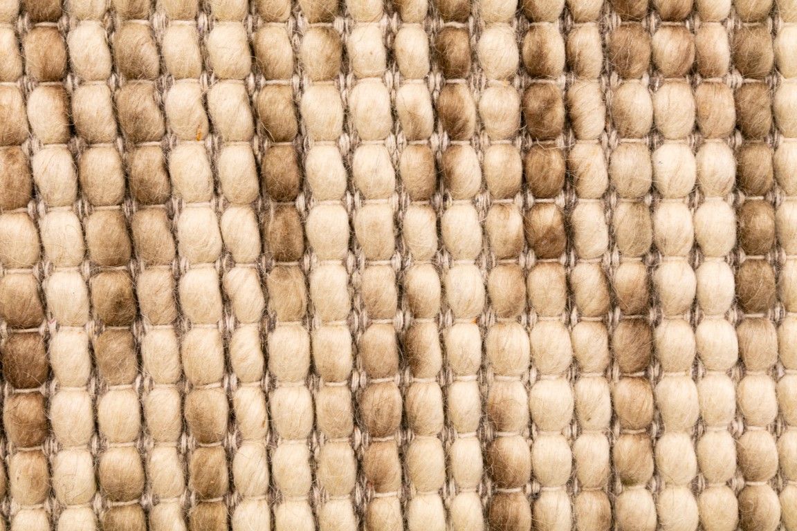 Dasha Natural is a texture hand woven rug made of 80%  New Zealand Wool and 20% Polyester. Colour Beige with Brown accents. Sizes 155 X 225, 200 X 290, 240 X 320 and 300 X 400. Close.