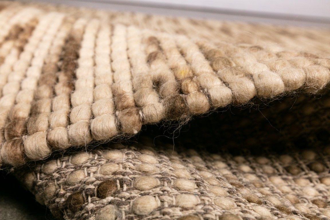 Dasha Natural is a texture hand woven rug made of 80%  New Zealand Wool and 20% Polyester. Colour Beige with Brown accents. Sizes 155 X 225, 200 X 290, 240 X 320 and 300 X 400. Side.
