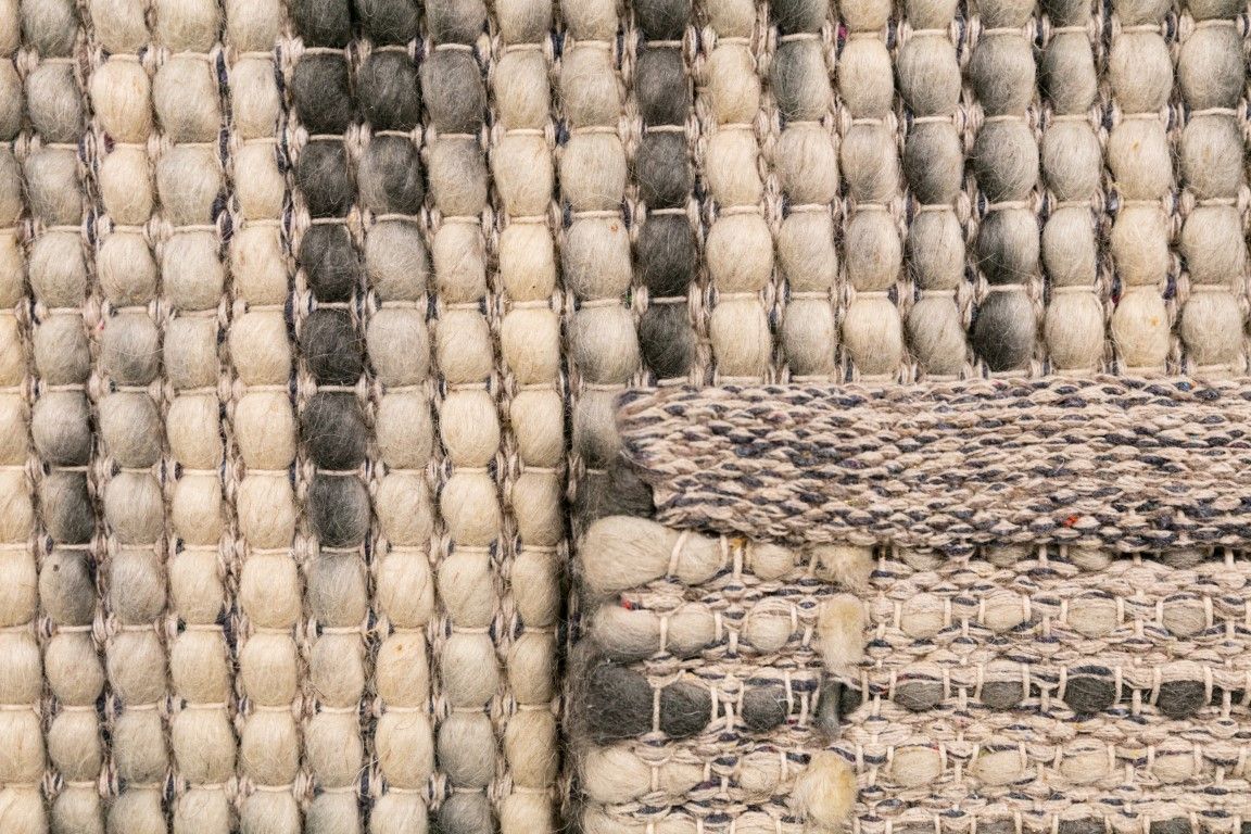 Dasha Zephyr is a texture hand woven rug made of 80%  New Zealand Wool and 20% Polyester. Colour Light Beige with Emerald Green accents. Sizes 155 X 225, 200 X 290, 240 X 320 and 300 X 400. Fold.