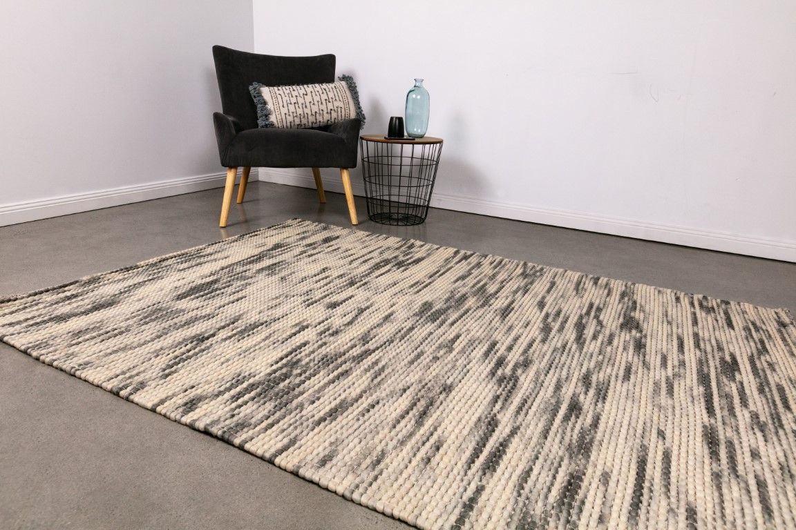 Dasha Zephyr is a texture hand woven rug made of 80%  New Zealand Wool and 20% Polyester. Colour Light Beige with Emerald Green accents. Sizes 155 X 225, 200 X 290, 240 X 320 and 300 X 400. Life.