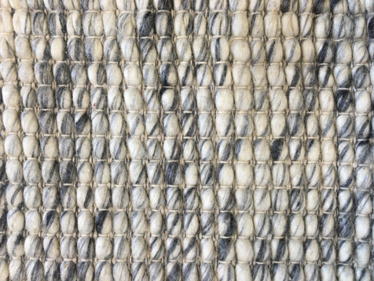 Dasha Round - Grey rug. Made of 80% wool and 20% polyester, this round rug features a unique textured design that adds a cozy and inviting feel to any room. Measuring 200cm in diameter. Close.