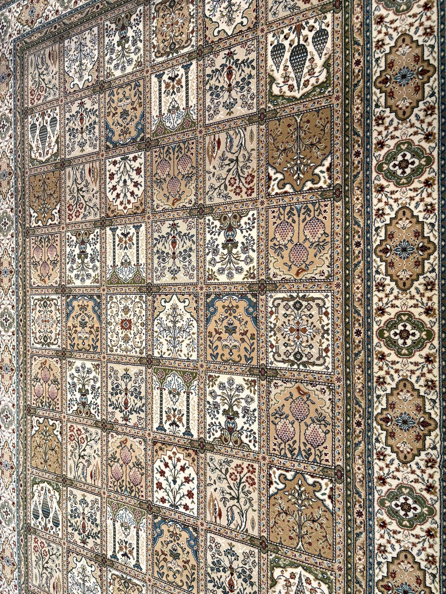 Davinci Bakhtiari Light Persian Rug. Machine made and specially crafted with heat-set polypropylene for long-lasting durability. Featuring a traditional Persian design. Colours, beige/multi. 3 sizes. Angle.