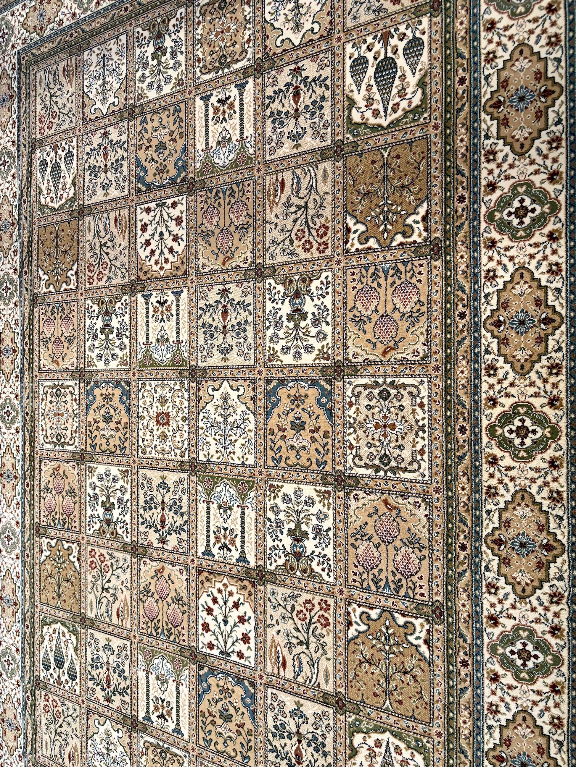 Davinci Bakhtiari Light Persian Rug. Machine made and specially crafted with heat-set polypropylene for long-lasting durability. Featuring a traditional Persian design. Colours, beige/multi. 3 sizes. Angle.