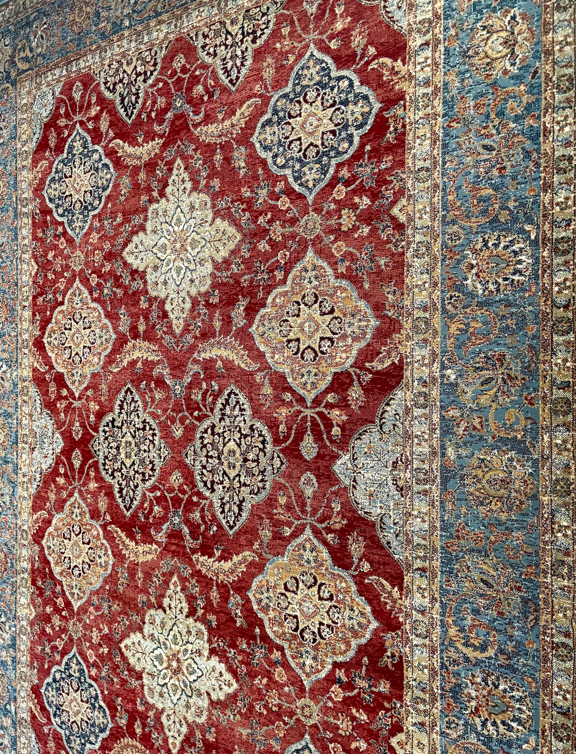The Davinci Heriz Red Persian Rug. Machine made and crafted from durable heat-set polypropylene. The classic  Persian design will elevate your home decor. Colours, reds, blues, beiges. 4 Sizes. Angle.
