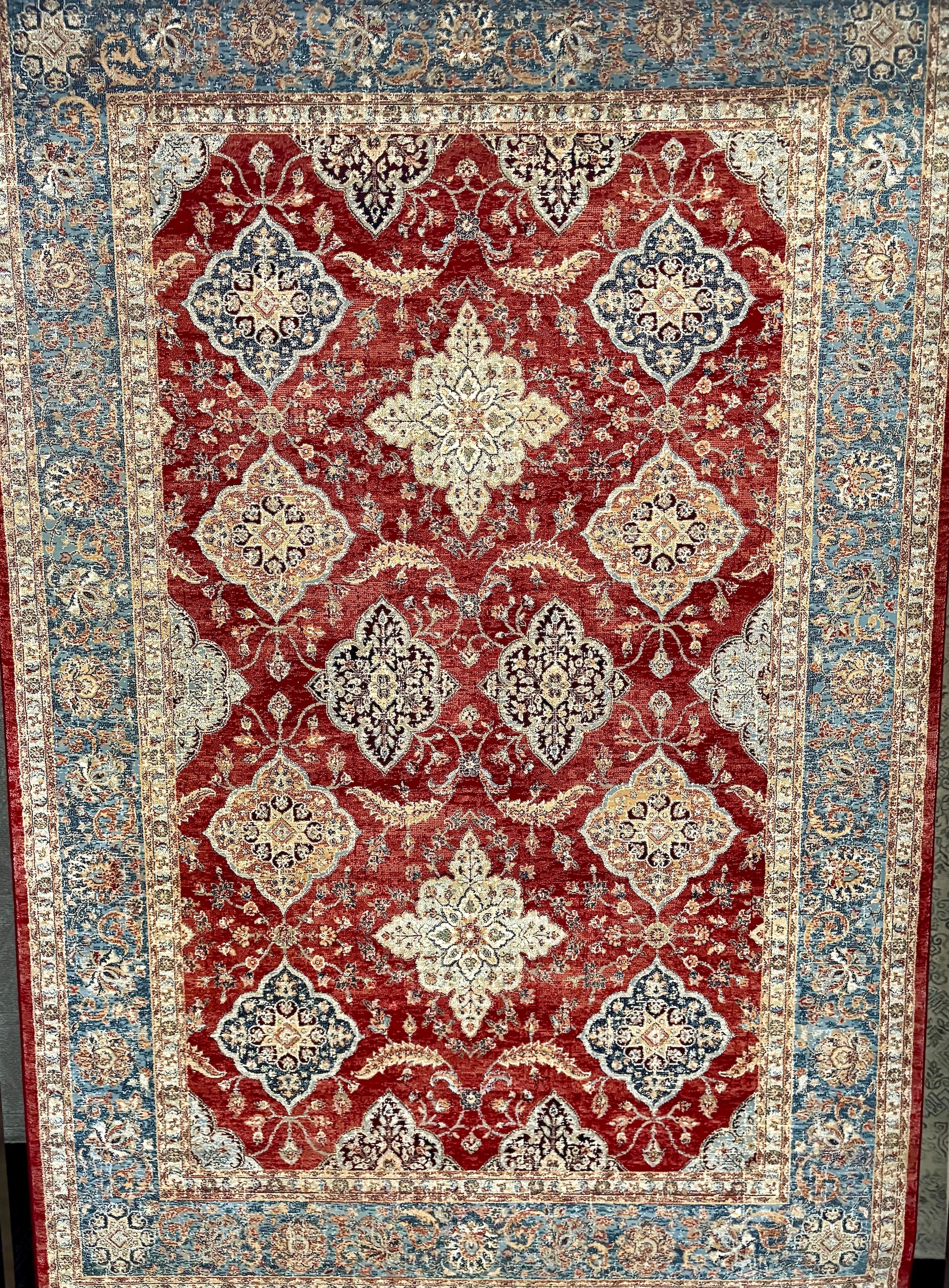The Davinci Heriz Red Persian Rug. Machine made and crafted from durable heat-set polypropylene. The classic  Persian design will elevate your home decor. Colours, reds, blues, beiges. 4 Sizes. Full.