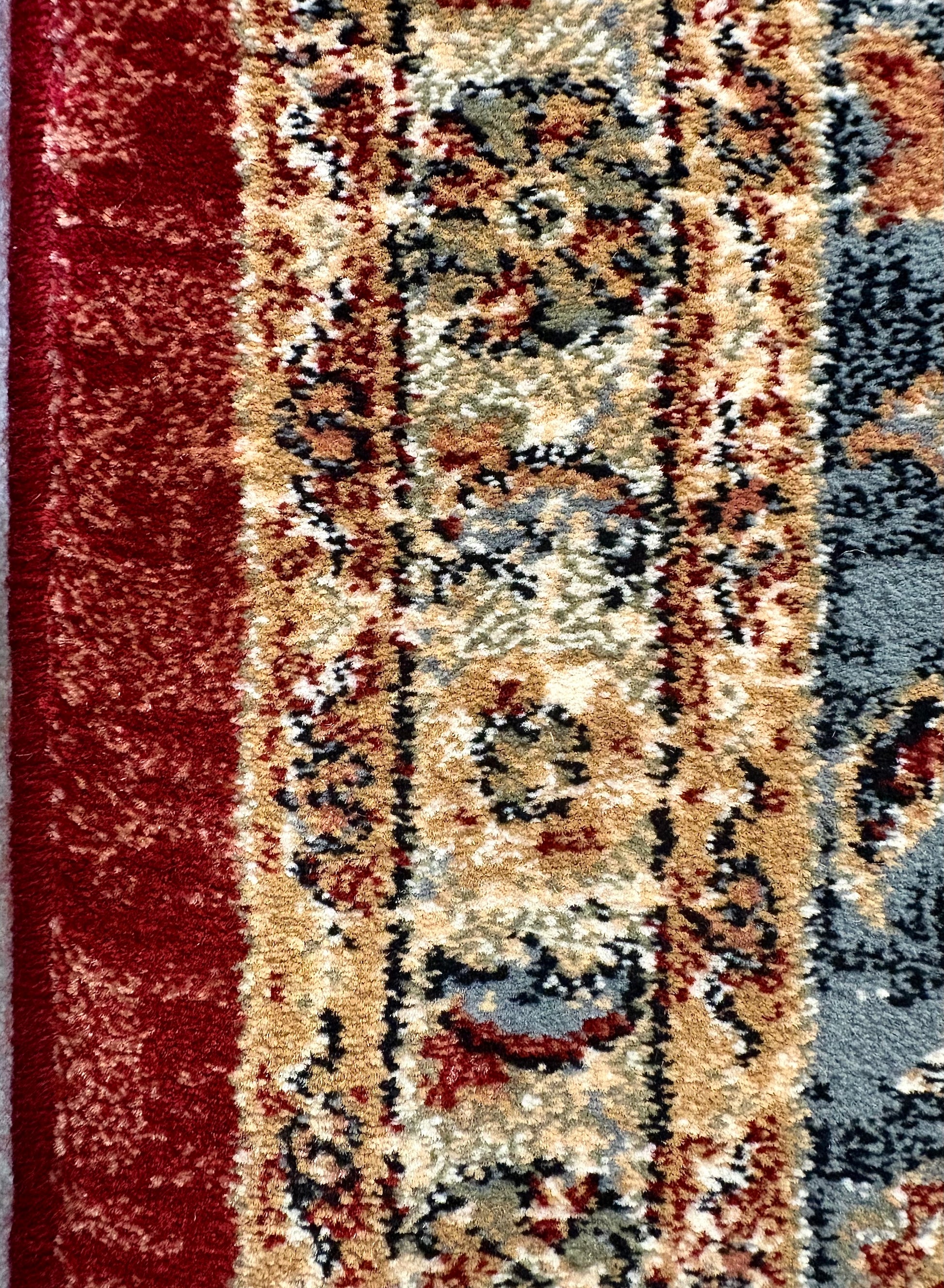 The Davinci Heriz Red Persian Rug. Machine made and crafted from durable heat-set polypropylene. The classic  Persian design will elevate your home decor. Colours, reds, blues, beiges. 4 Sizes. Side Close.