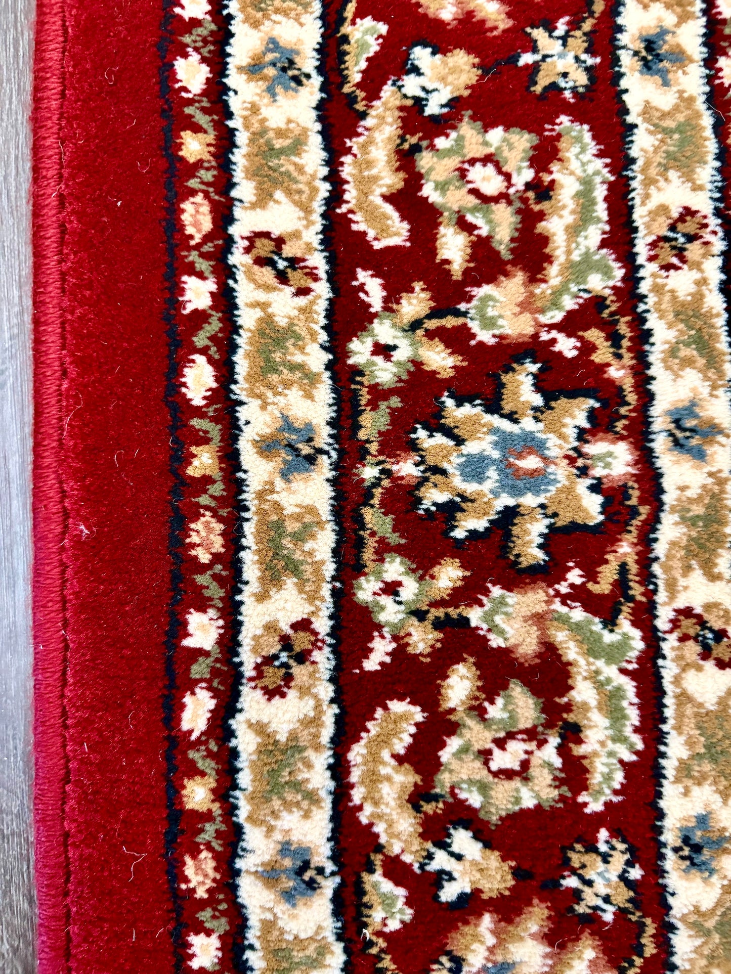 The Davinci Isfahan Beige machine-made Persian rug offers lasting style and durability, expertly crafted with heat-set polypropylene for enduring comfort. Colours, reds, beiges, greys. 4 Sizes. Side Close.
