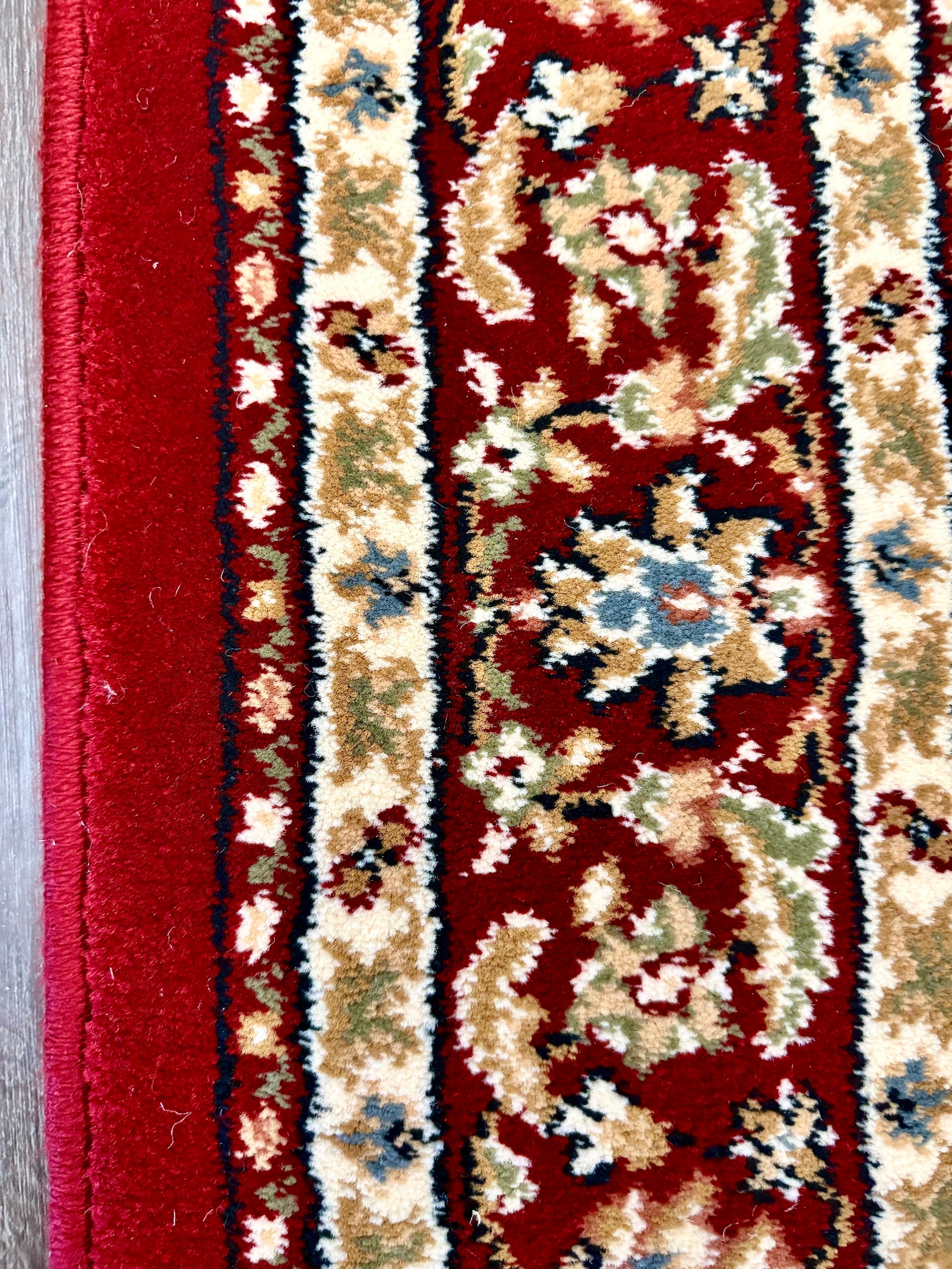 The Davinci Isfahan Beige machine-made Persian rug offers lasting style and durability, expertly crafted with heat-set polypropylene for enduring comfort. Colours, reds, beiges, greys. 4 Sizes. Side Close.