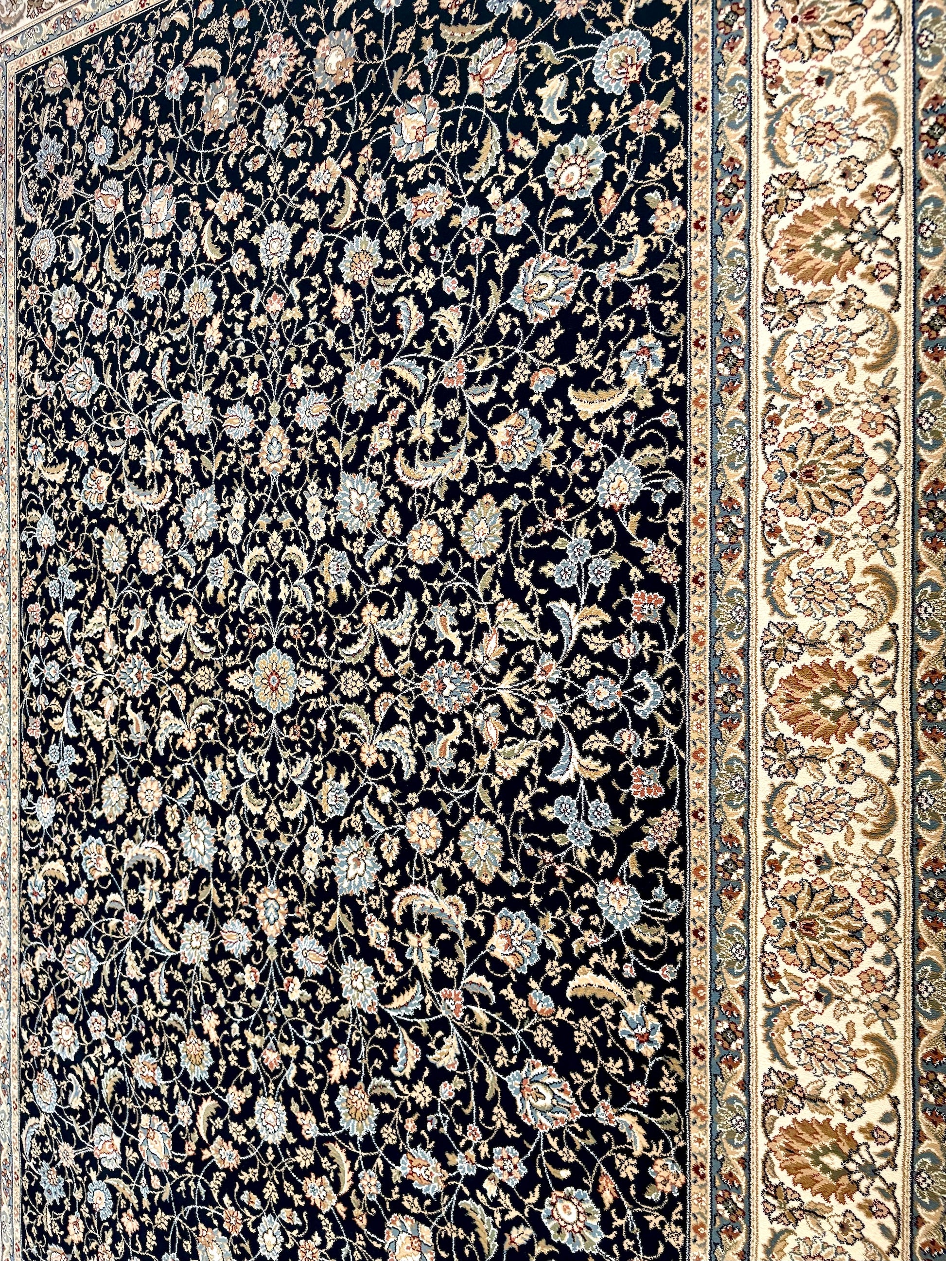 The Davinci Isfahan Blue machine-made Persian rug offers lasting style and durability, expertly crafted with heat-set polypropylene for enduring comfort. Colours, dark blues, beiges, browns. 4 Sizes. Angle.