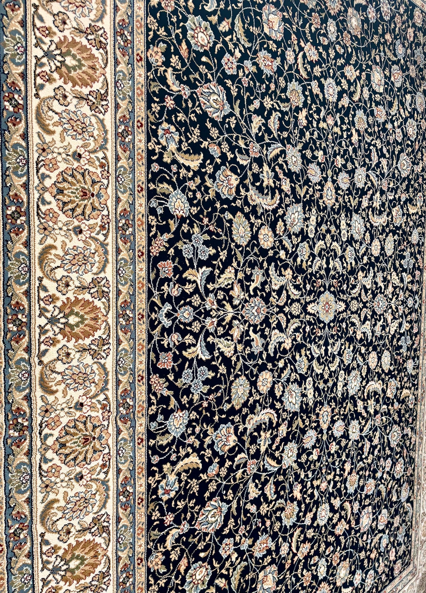 The Davinci Isfahan Blue machine-made Persian rug offers lasting style and durability, expertly crafted with heat-set polypropylene for enduring comfort. Colours, dark blues, beiges, browns. 4 Sizes. Close Angle.