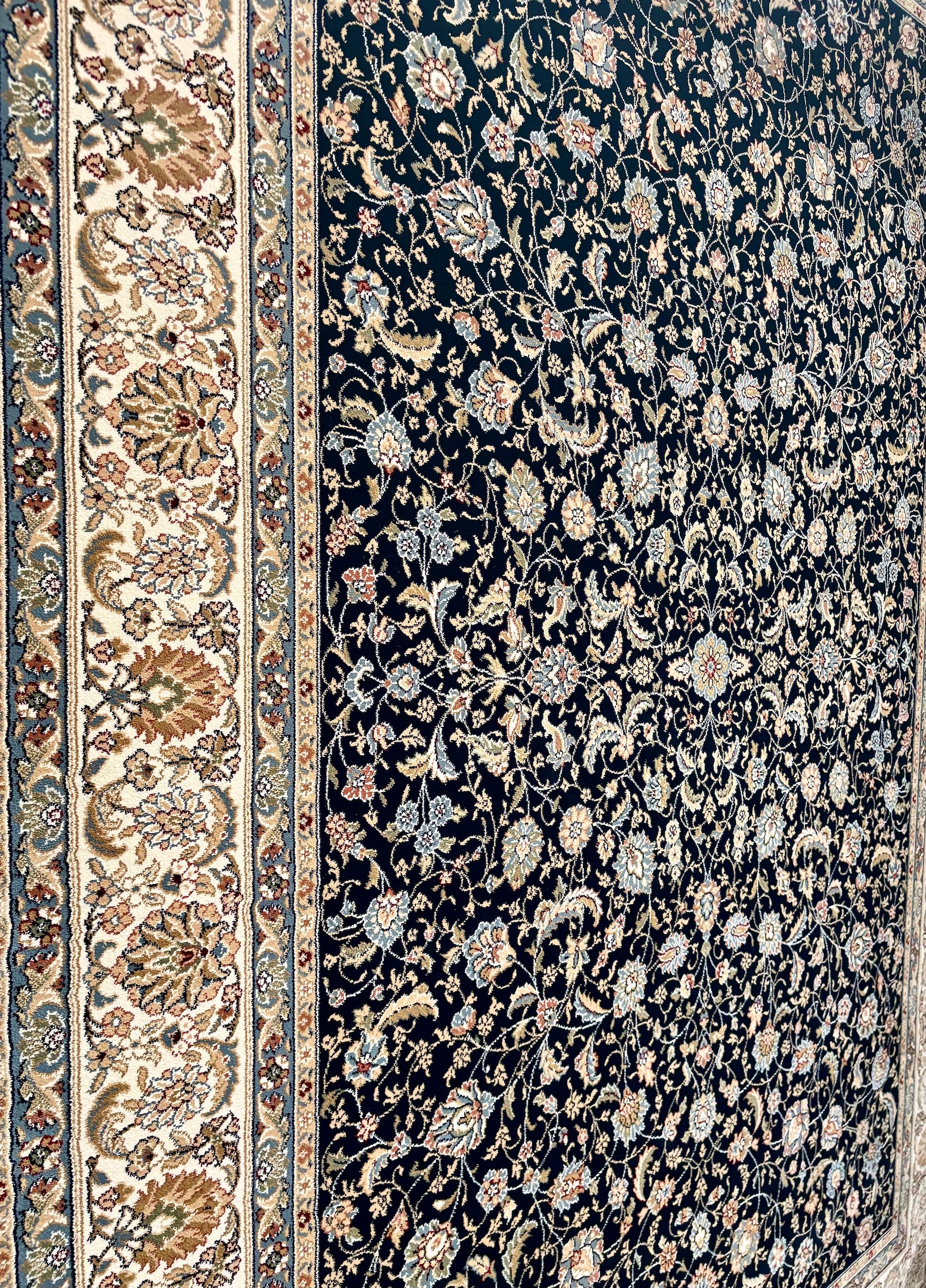 The Davinci Isfahan Blue machine-made Persian rug offers lasting style and durability, expertly crafted with heat-set polypropylene for enduring comfort. Colours, dark blues, beiges, browns. 4 Sizes. Close Angle.