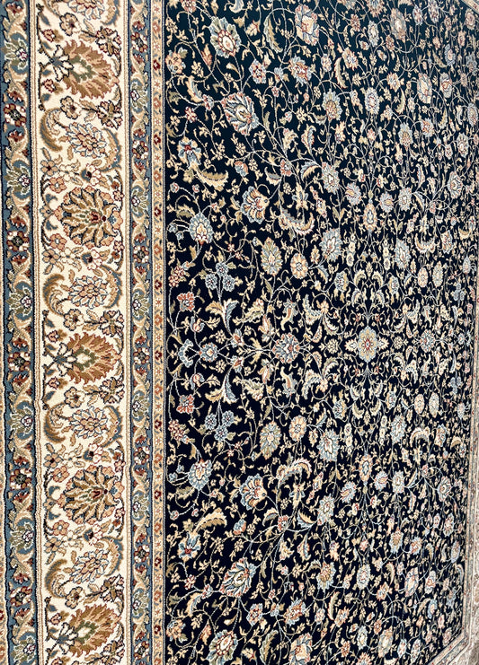 The Davinci Isfahan Blue machine-made Persian rug offers lasting style and durability, expertly crafted with heat-set polypropylene for enduring comfort. Colours, dark blues, beiges, browns. 4 Sizes. Close Angle.