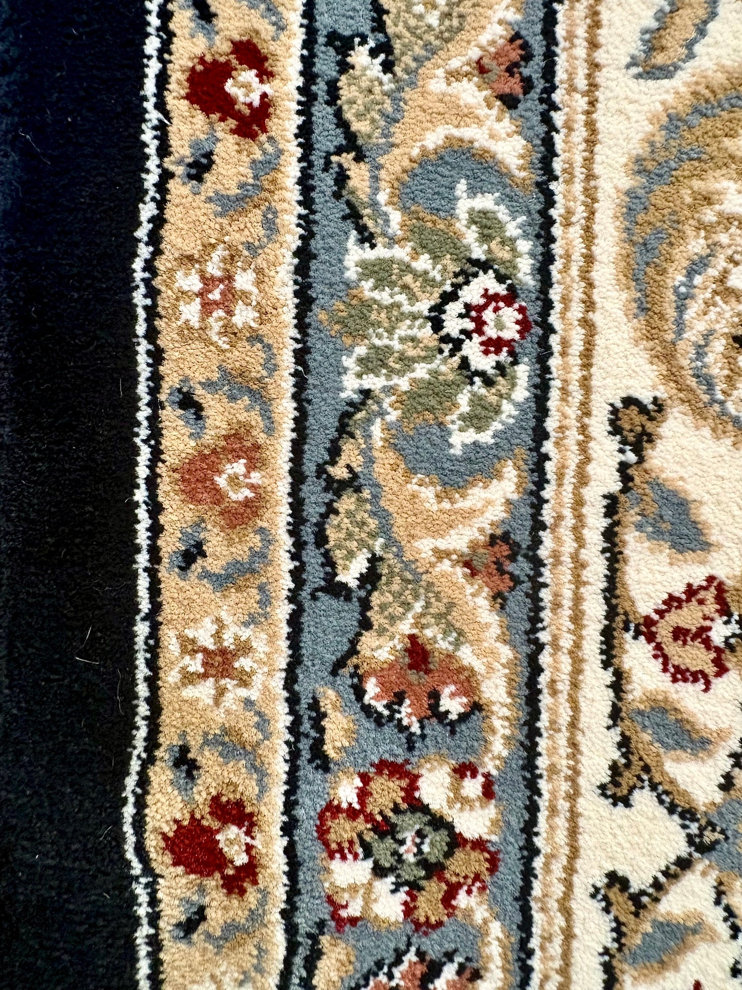 The Davinci Isfahan Blue machine-made Persian rug offers lasting style and durability, expertly crafted with heat-set polypropylene for enduring comfort. Colours, dark blues, beiges, browns. 4 Sizes. Side Close.