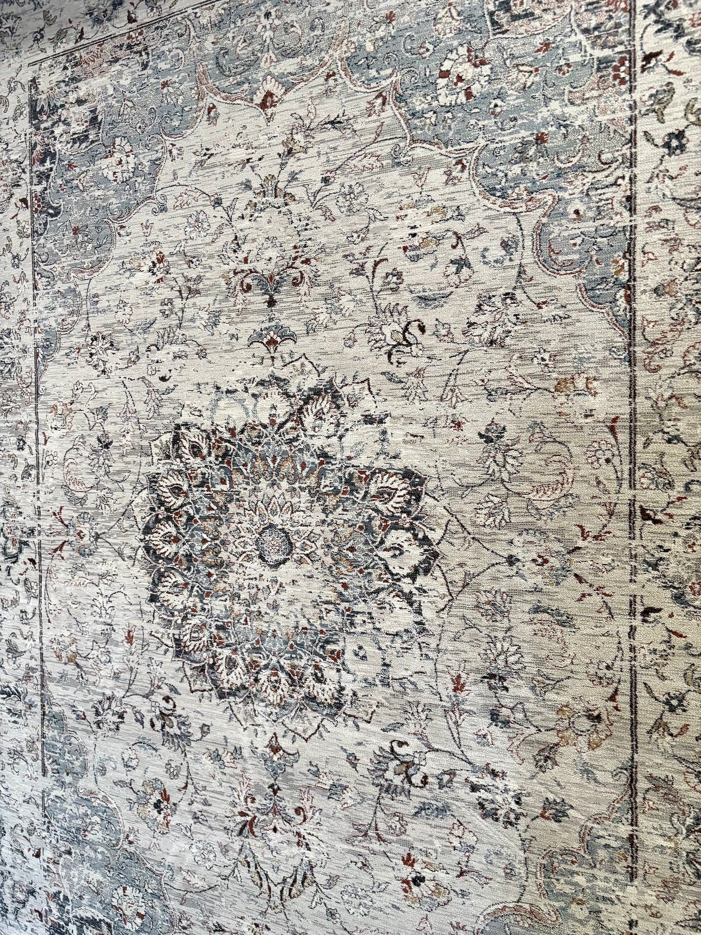 The Davinci Medallion Grey machine-made Persian rug offers traditional style and durability, expertly crafted with heat-set polypropylene for enduring comfort. Colours, Greys, light greys. 3 Sizes. Angle.