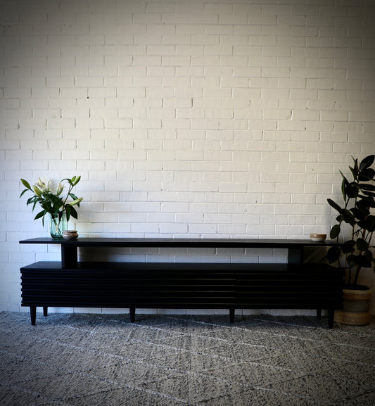 The Dean Black 2400 Entertainment Unit features a floating top shelf.  With 3 textured drawers and stylish turned legs. Colour Black. Measures 2400 Length X 400 Depth X 650 Height. Front Styled.