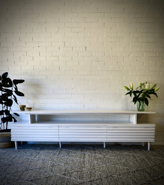 The Dean White 2400 Entertainment Unit features a floating top shelf.  With 3 textured drawers and stylish turned legs. Colour White. Measures 2400 Length X 400 Depth X 650 Height. Front Styled.