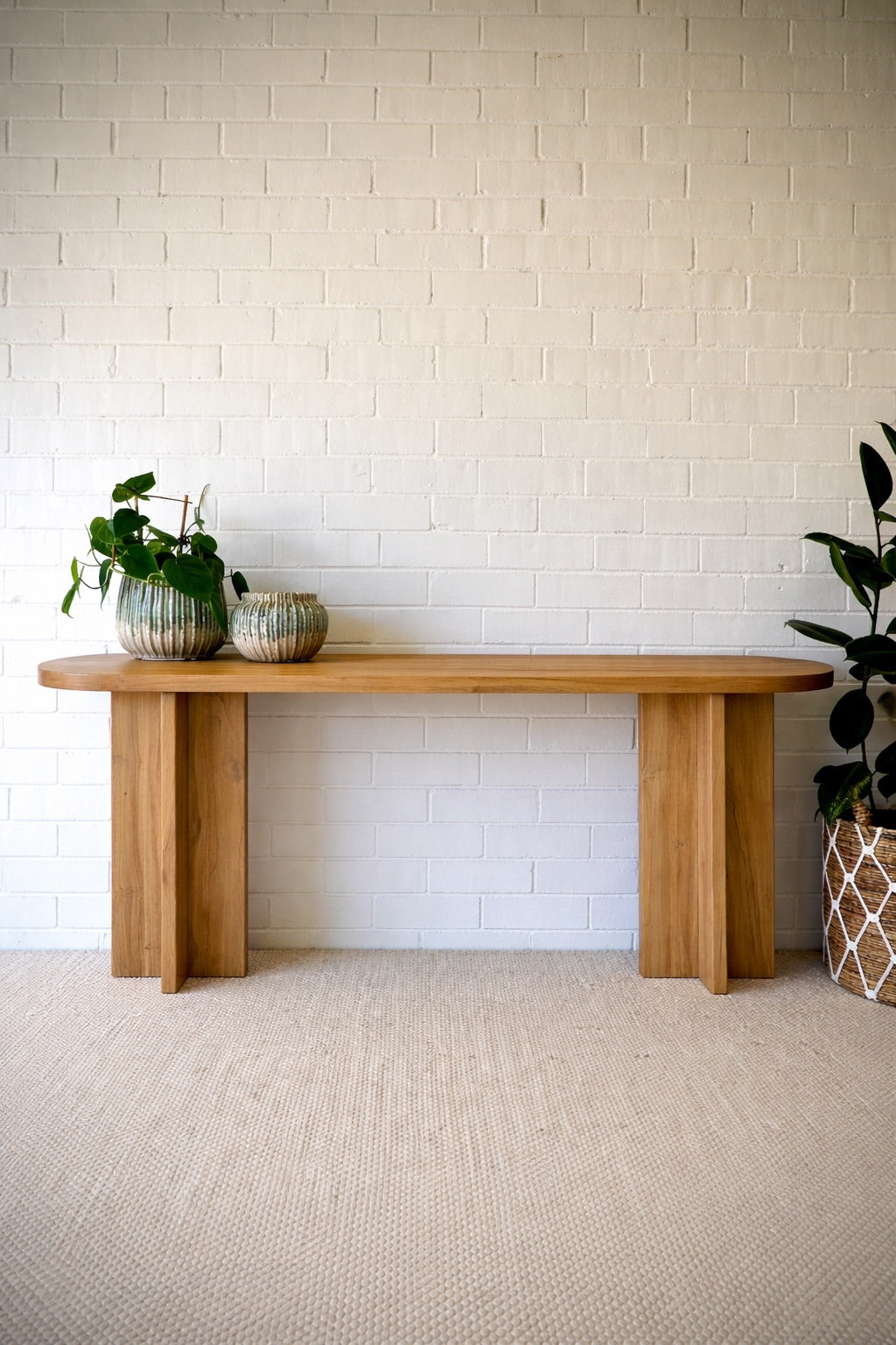 Dublin Teak Top Console crafted from solid teak. Featuring solid teak top with rounded ends and solid panel-styled pillar supports. Colour Natural Teak. Measures 1800 Wide X 380 Depth X 800 Height. Styled.