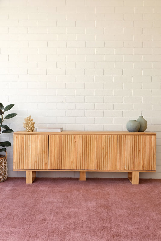 The Eastwood Natural Entertainment Unit. 4 textured doors with smart storage behind the left door featuring 3 drawer. Colour Natural. Measures 1800 wide X 400 depth x 650 height. Styled.