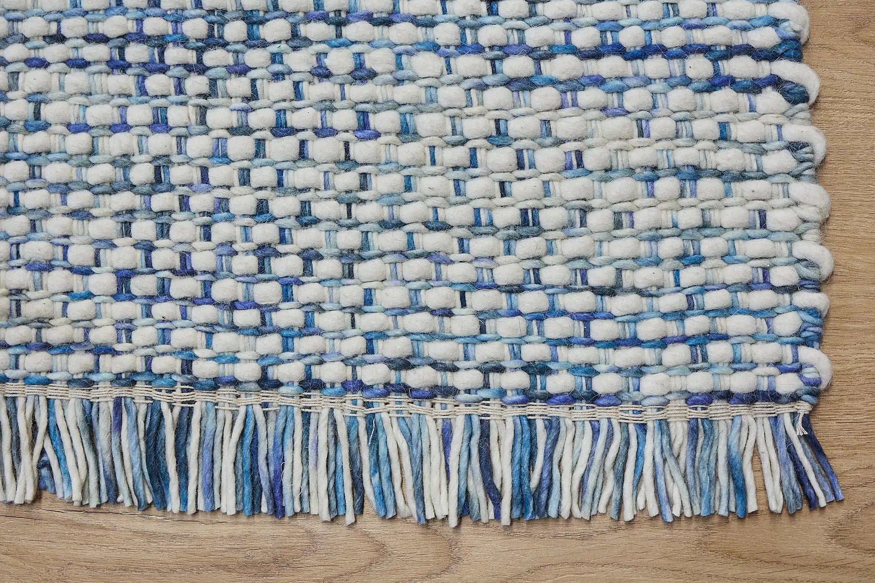 Fancy Mist is a hand braided wool rug with a sumptuous 12-14mm medium pile height. Colours White with blue accents. Sizes 160 X 230, 200 X 290, 240 X 340 and 290 X 390. Corner.