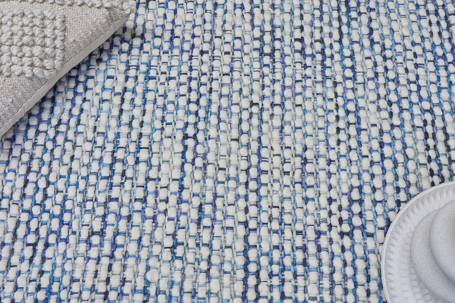 Fancy Mist is a hand braided wool rug with a sumptuous 12-14mm medium pile height. Colours White with blue accents. Sizes 160 X 230, 200 X 290, 240 X 340 and 290 X 390. Life.