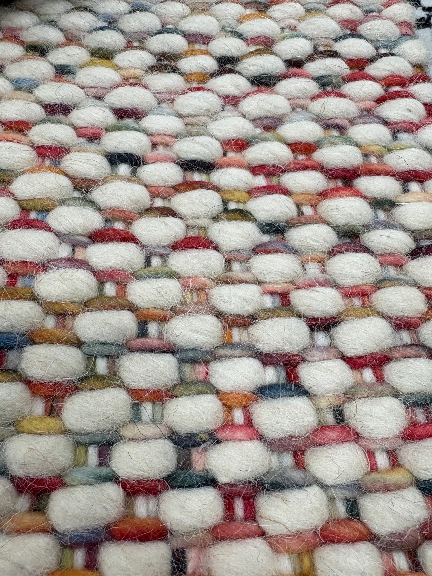 Fancy Red is a hand braided wool rug with a sumptuous 12-14mm medium pile height. Colours White with red and multi coloured accents. Sizes 160 X 230, 200 X 290, 240 X 340. Close.