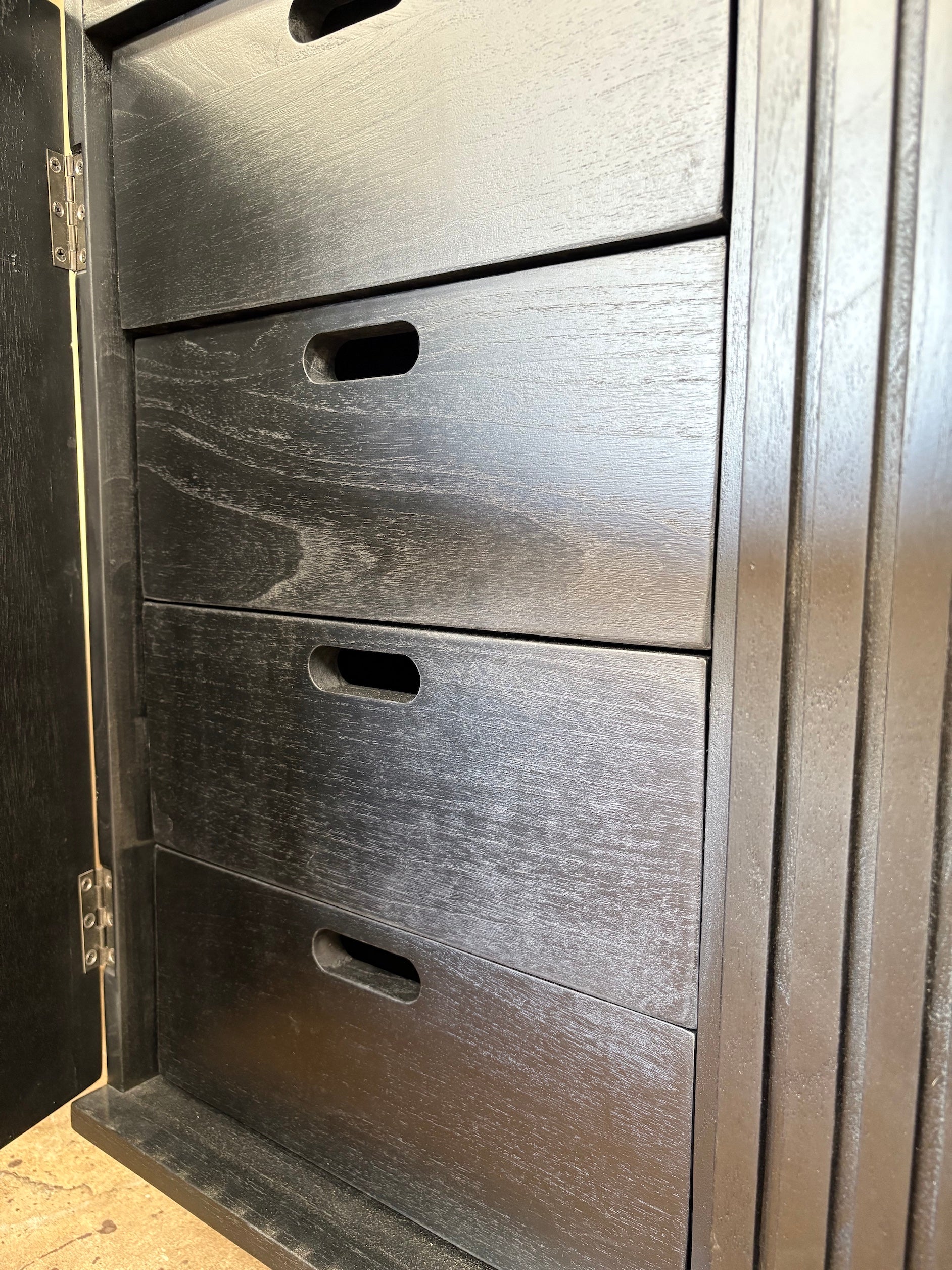 The Florence Black Buffet. 4 textured doors with smart storage behind the left door featuring 4 drawers. Colour Black. Measures 1800 wide X 400 depth x 900 height. Drawers.