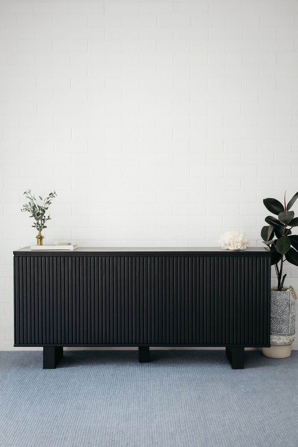 The Florence Black Buffet. 4 textured doors with smart storage behind the left door featuring 4 drawers. Colour Black. Measures 1800 wide X 400 depth x 900 height. Styled.