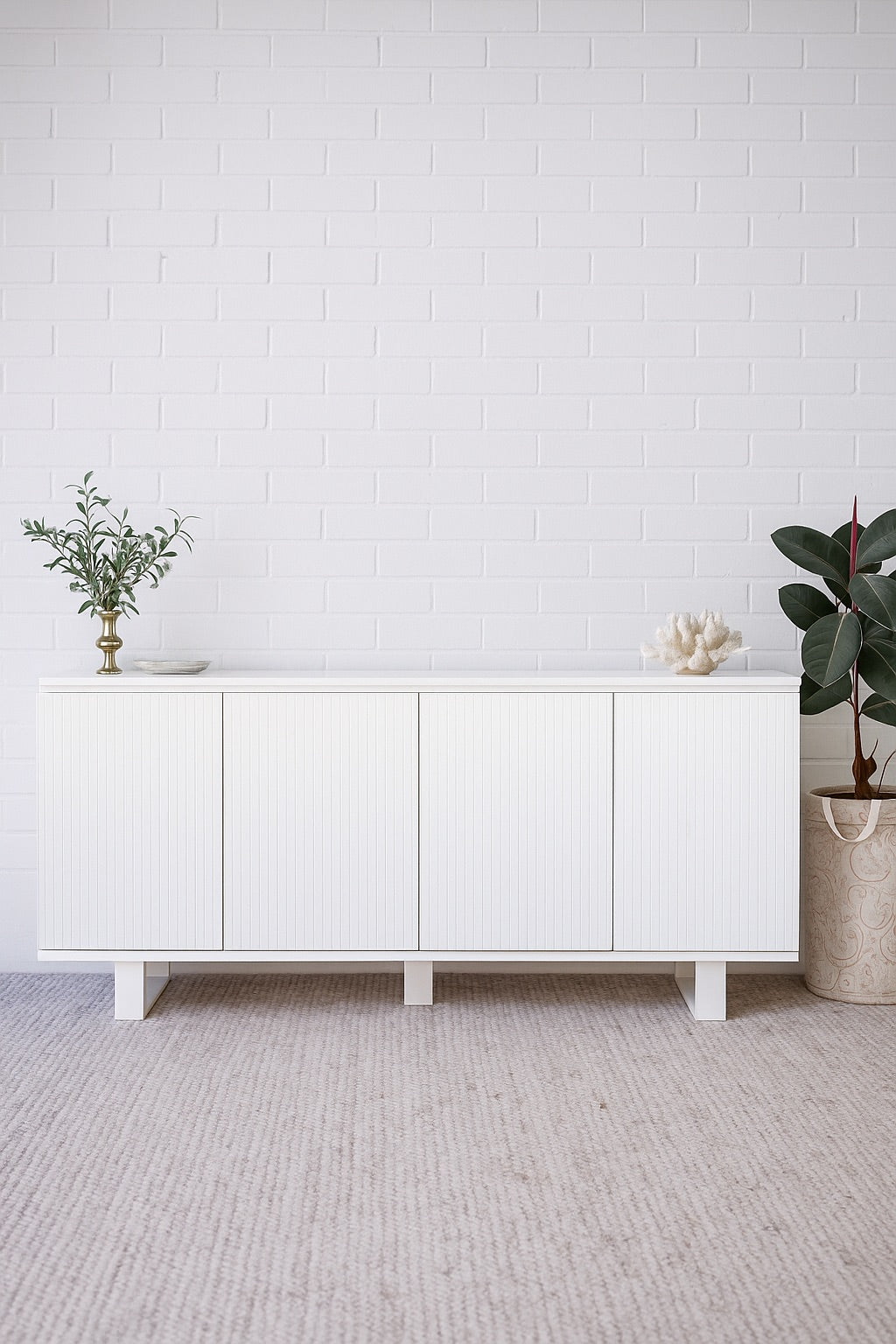 The Florence White Buffet. 4 textured doors with smart storage behind the left door featuring 4 drawers. Colour White. Measures 1800 wide X 400 depth x 900 height. Styled.