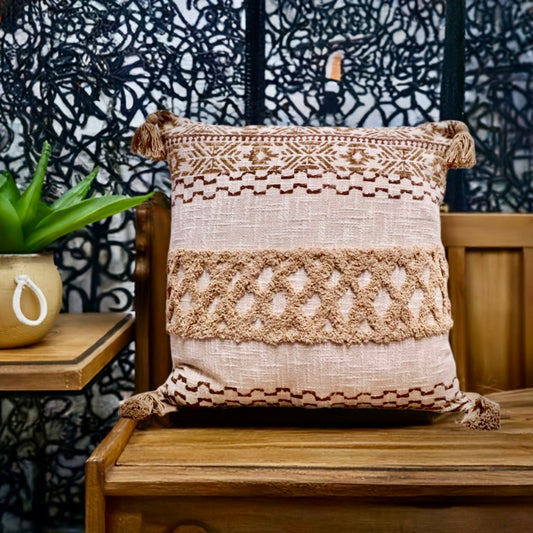The Folk Tale block print in hand crafted in India.  Made from durable soft cotton, it features geometric designs and a textured pattern with tasseled corners.  Colours, beige, oranges, browns and greys.  Measures 50 X 50. Styled.