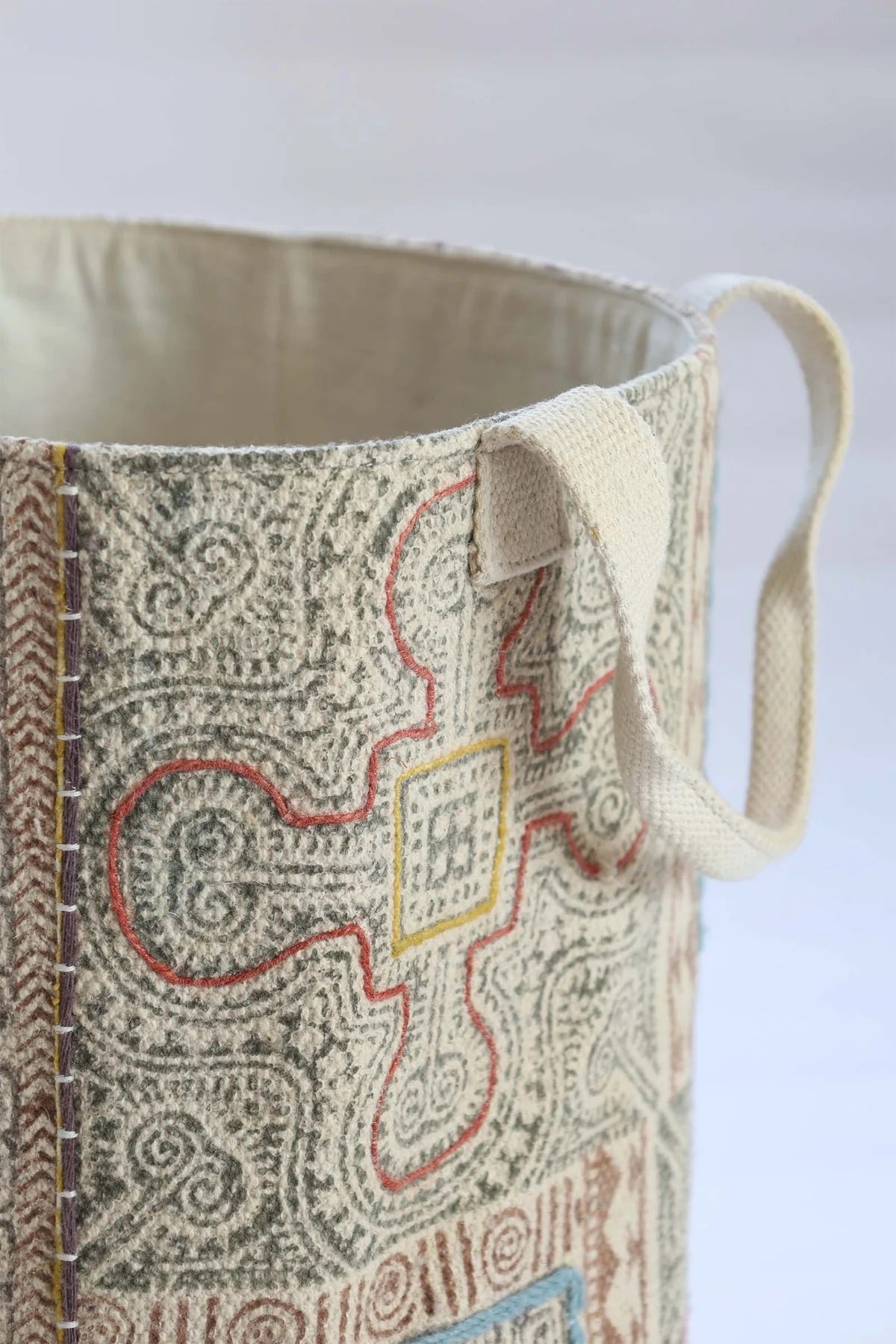 The Frosted Art Cotton Block Print Basket featuring a bold block print design and sturdy handles. Features a cotton liner and texture cotton outer shell. Colours, creams, browns, oranges, light blues. Measures 400 height X 350 diameter. Top Corner.
