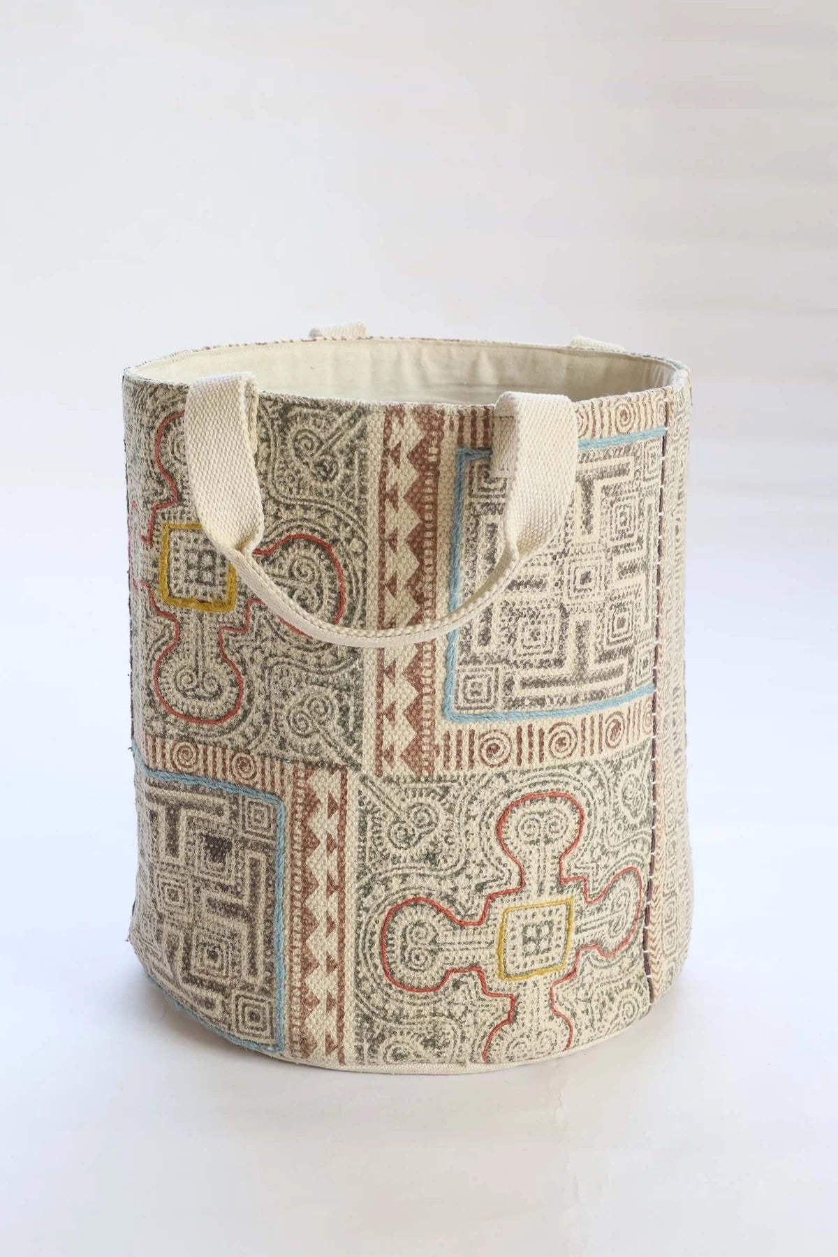 The Frosted Art Cotton Block Print Basket featuring a bold block print design and sturdy handles. Features a cotton liner and texture cotton outer shell. Colours, creams, browns, oranges, light blues. Measures 400 height X 350 diameter. Side Front Plain.