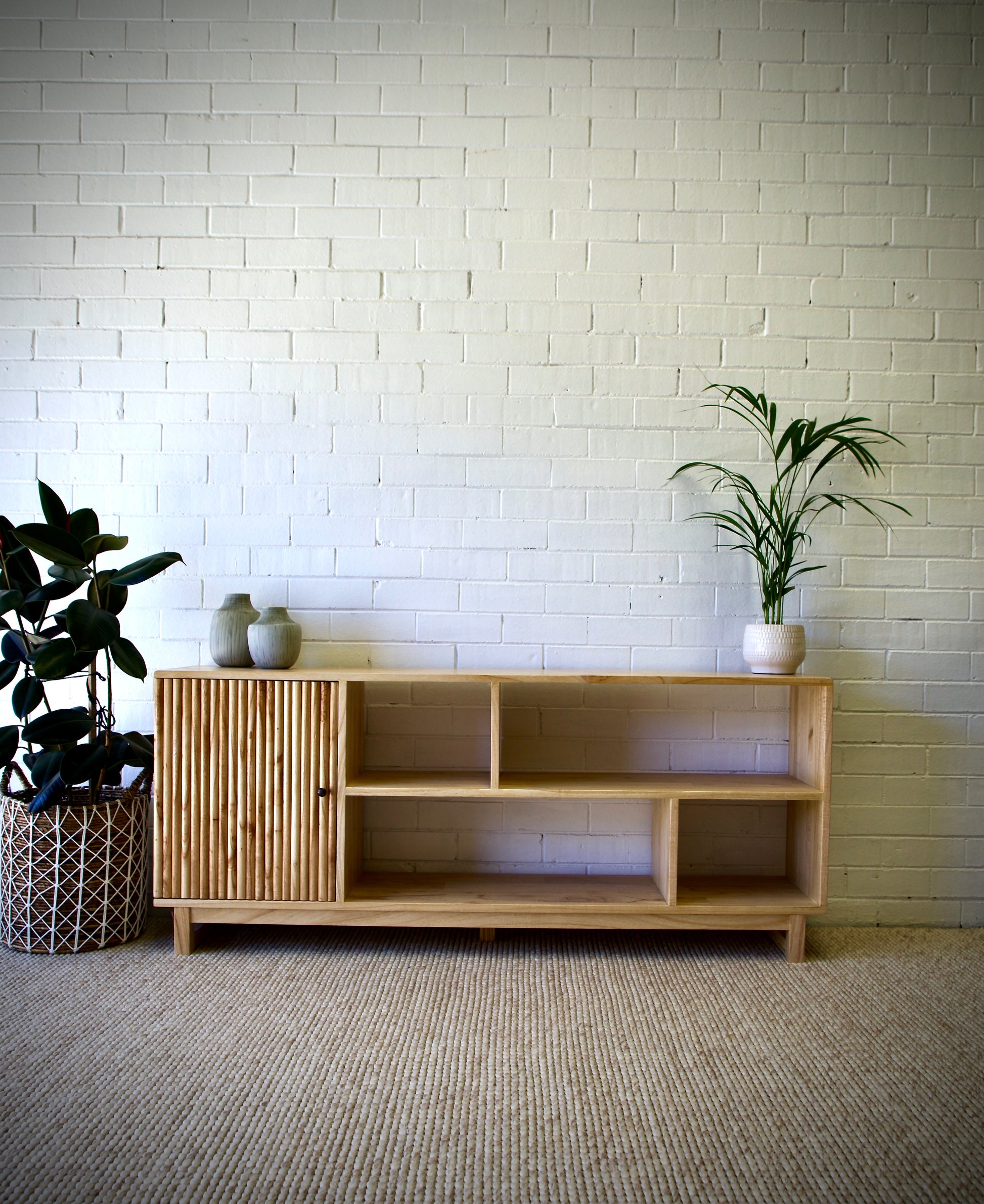 The Gemini 1 Door bookshelf is a contemporary stylish piece. It is crafted from white cedar and features multiple shelves and a single textured door. Colour natural. Measures 1650 length X 350 depth X 700 height. Front Styled.