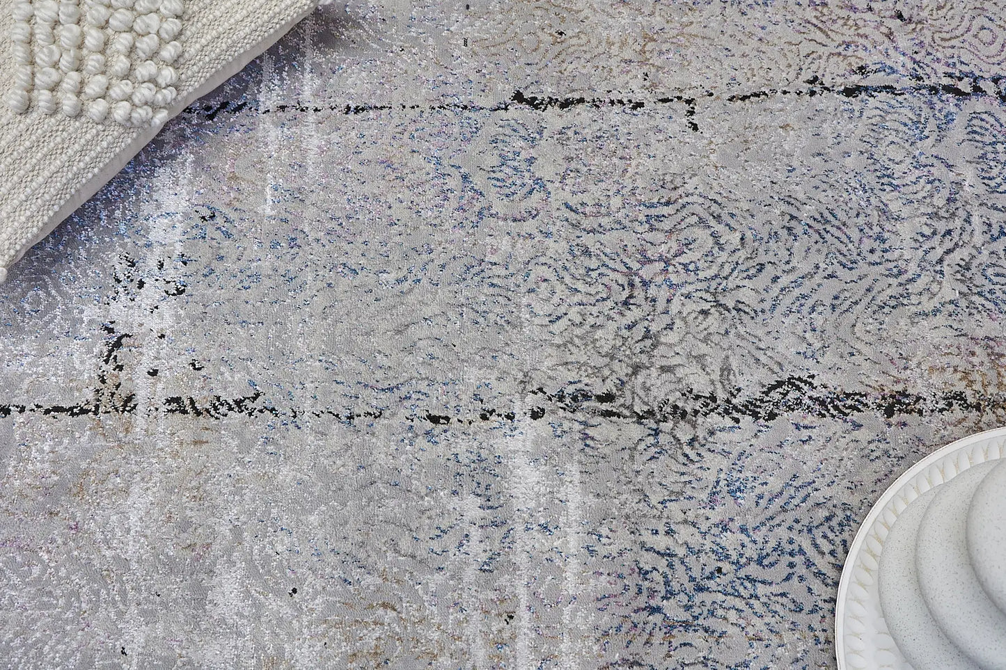 Geneva Grey is a machine made rug. Its design boasts a abstract modern/contemporary feel. Crafted from Viscose and Polyester, with a low-profile 7-9mm pile height. Colours Light Grey with Blue and Black accent tones. Sizes 160 X 230, 200 X 290 and 240 X 340. Life.