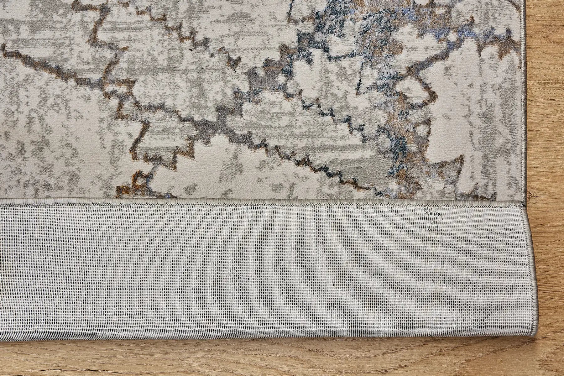 Geneva Taupe is a machine made rug. Its design boasts a abstract modern/contemporary feel. Crafted from Viscose and Polyester, with a low-profile 7-9mm pile height. Colours, Light Grey with Blue and white accent tones. Sizes 160 X 230, 200 X 290 and 240 X 340. Fold.