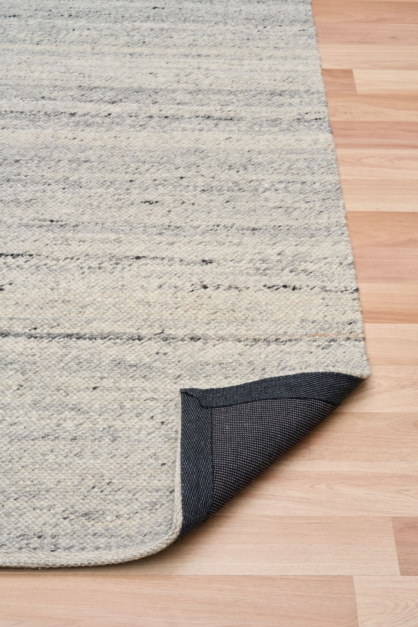 Harmony Grey Rug – hand-woven blend of wool and viscose in soft natural tones, featuring a textured finish that’s both elegant and durable. Colour White, Grey, black and brown flecks. 4 sizes. Fold.
