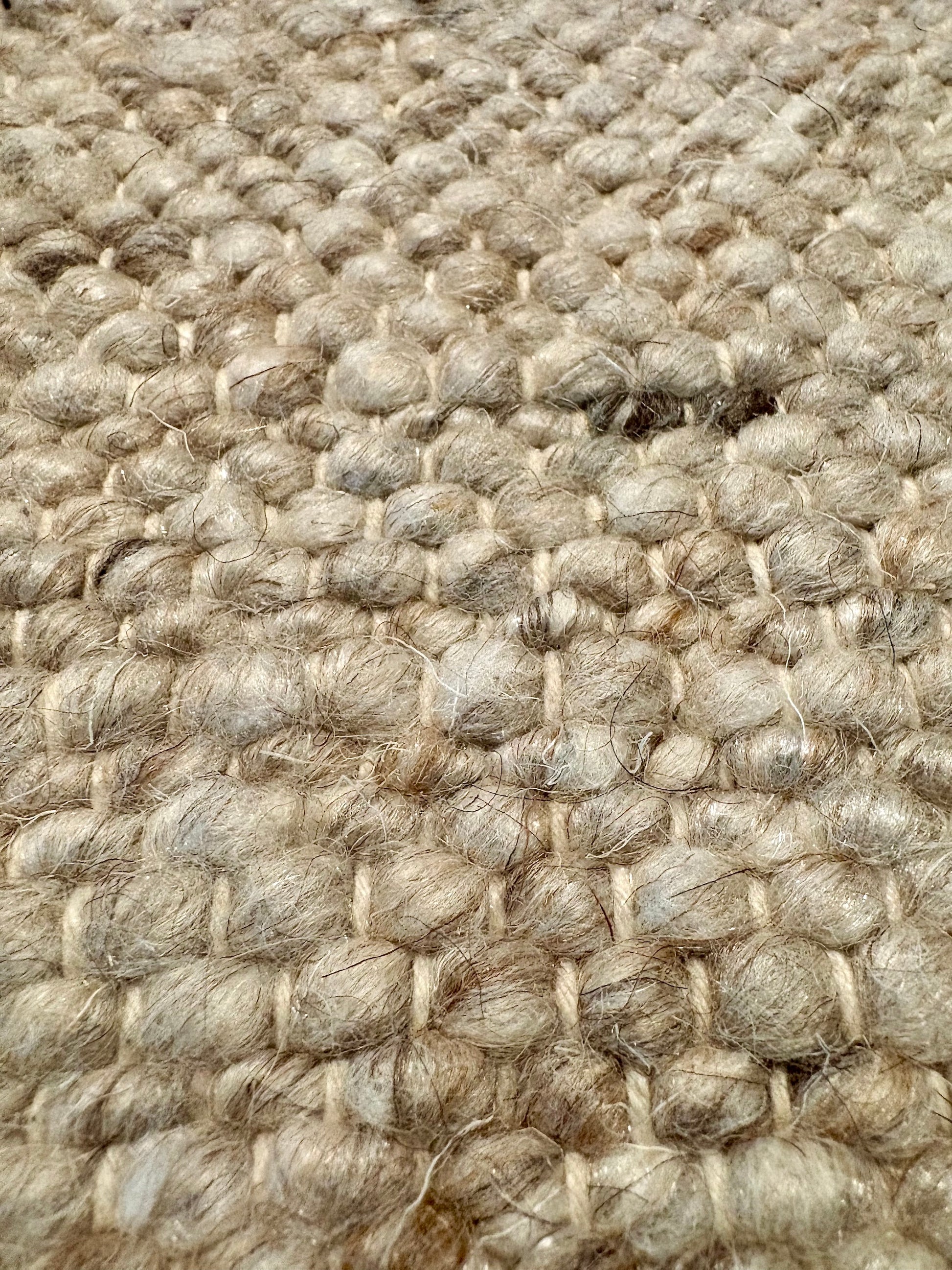 Harmony Beige Rug – hand-woven blend of wool and viscose in soft natural tones, featuring a textured finish that’s both elegant and durable. Colour White, Grey, black and brown flecks. 4 sizes. Super Close.