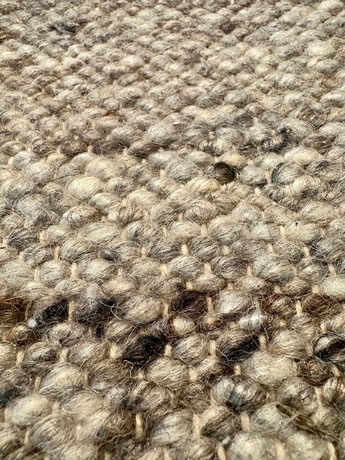 Harmony Dark Grey Rug – hand-woven blend of wool and viscose in soft natural tones, featuring a textured finish that’s both elegant and durable. Colour White, Grey, black and brown flecks. 3 sizes. Super Close.