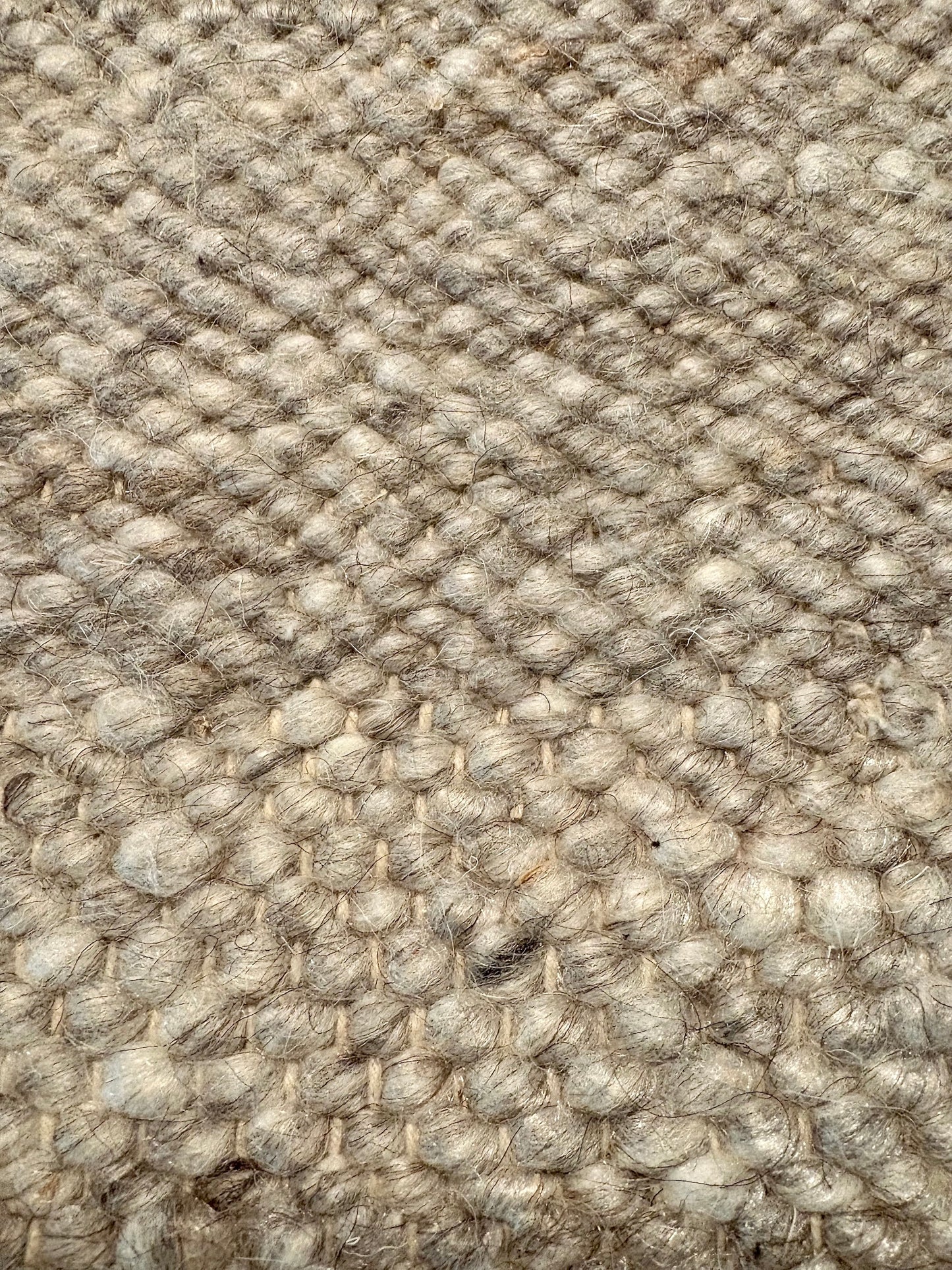 Harmony Grey Rug – hand-woven blend of wool and viscose in soft natural tones, featuring a textured finish that’s both elegant and durable. Colour White, Grey, black and brown flecks. 4 sizes. Up close.