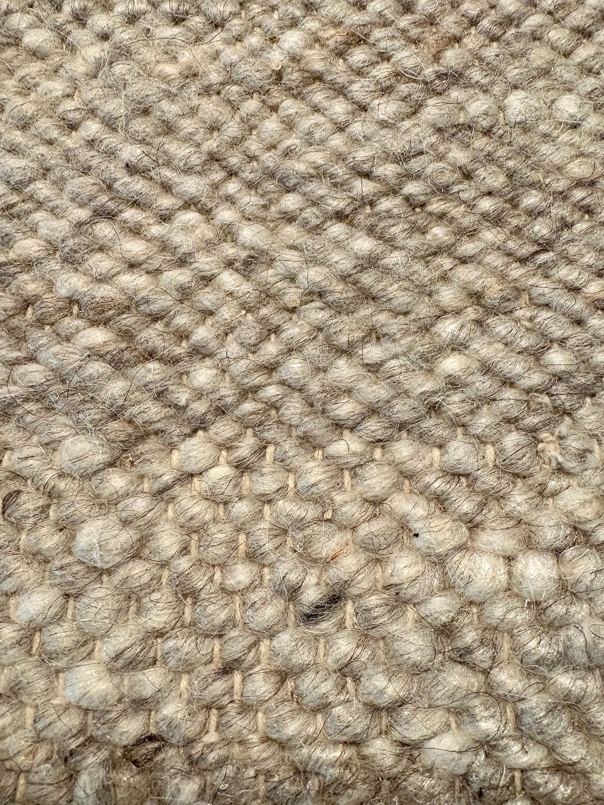 Harmony Grey Rug – hand-woven blend of wool and viscose in soft natural tones, featuring a textured finish that’s both elegant and durable. Colour White, Grey, black and brown flecks. 4 sizes. Up close.