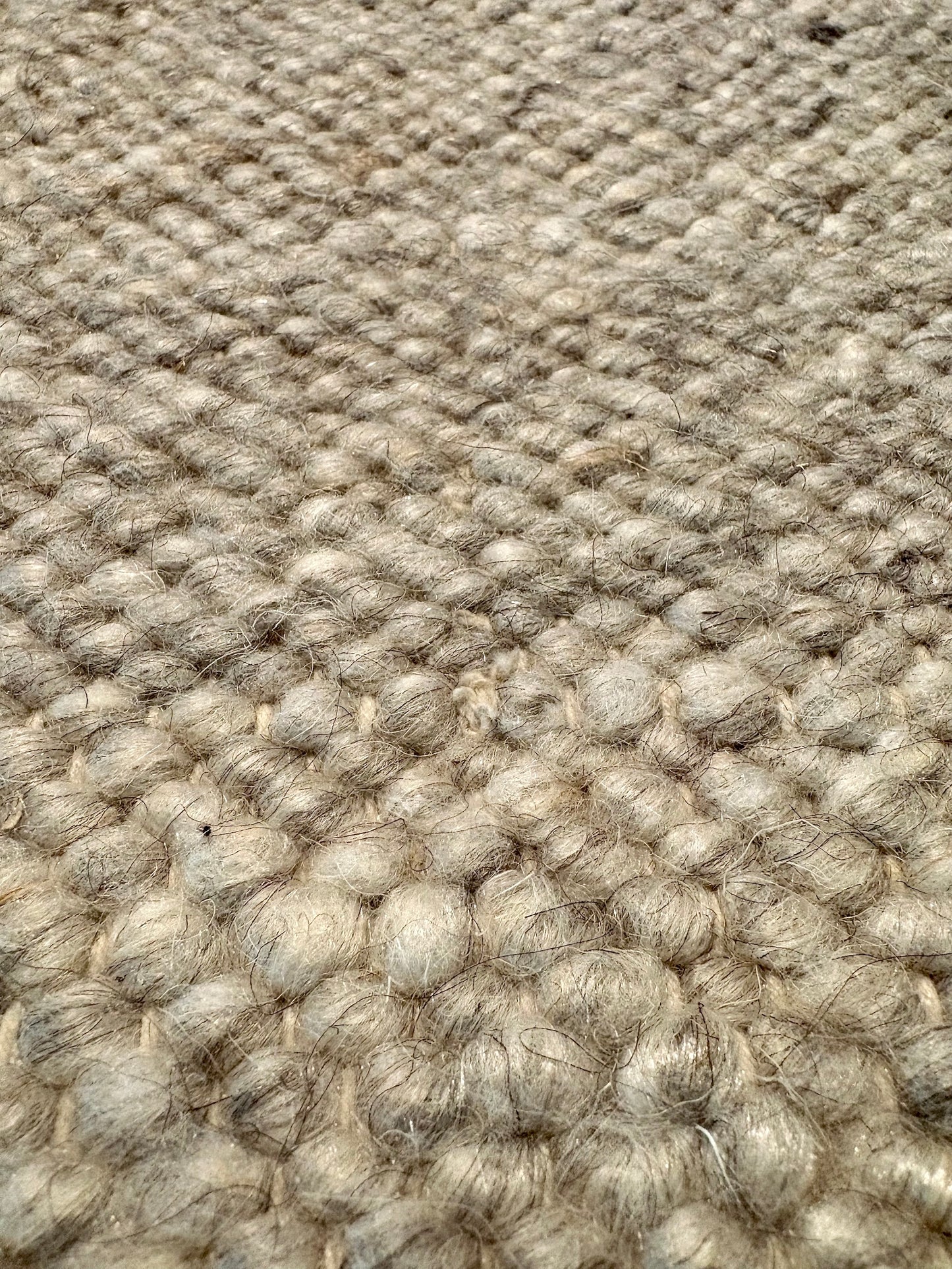 Harmony Grey Rug – hand-woven blend of wool and viscose in soft natural tones, featuring a textured finish that’s both elegant and durable. Colour White, Grey, black and brown flecks. 4 sizes. Super Close.