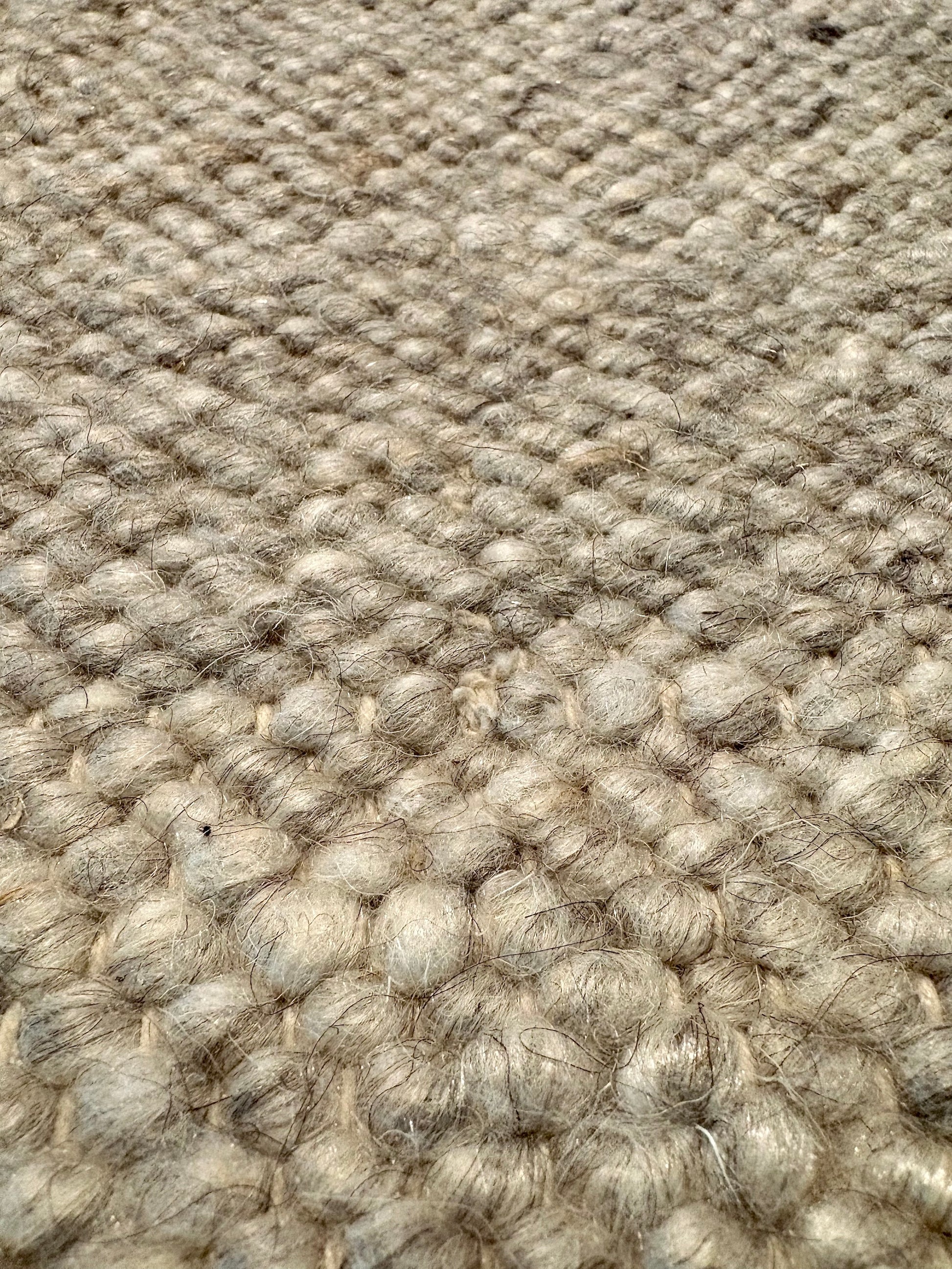 Harmony Grey Rug – hand-woven blend of wool and viscose in soft natural tones, featuring a textured finish that’s both elegant and durable. Colour White, Grey, black and brown flecks. 4 sizes. Super Close.