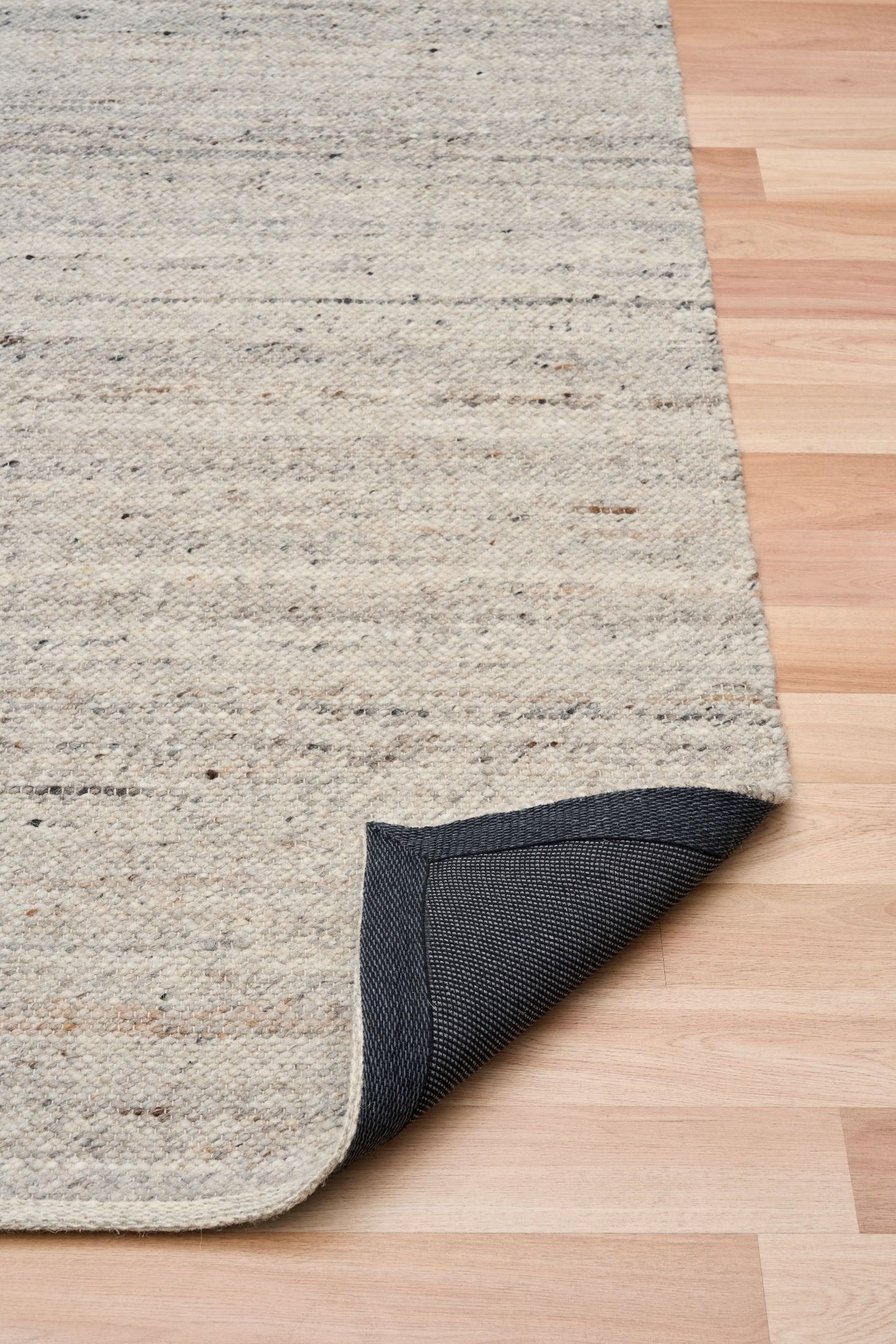 Harmony Smoke Grey Rug – hand-woven blend of wool and viscose in soft natural tones, featuring a textured finish that’s both elegant and durable. Colour White, Grey, black and brown flecks. 4 sizes. Fold.