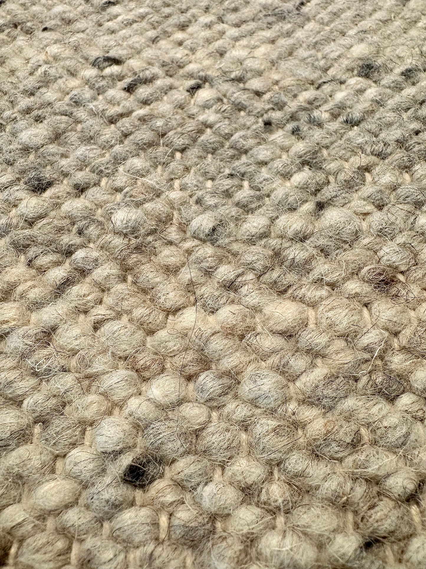 Harmony Smoke Grey Rug – hand-woven blend of wool and viscose in soft natural tones, featuring a textured finish that’s both elegant and durable. Colour White, Grey, black and brown flecks. 4 sizes. Super Close.
