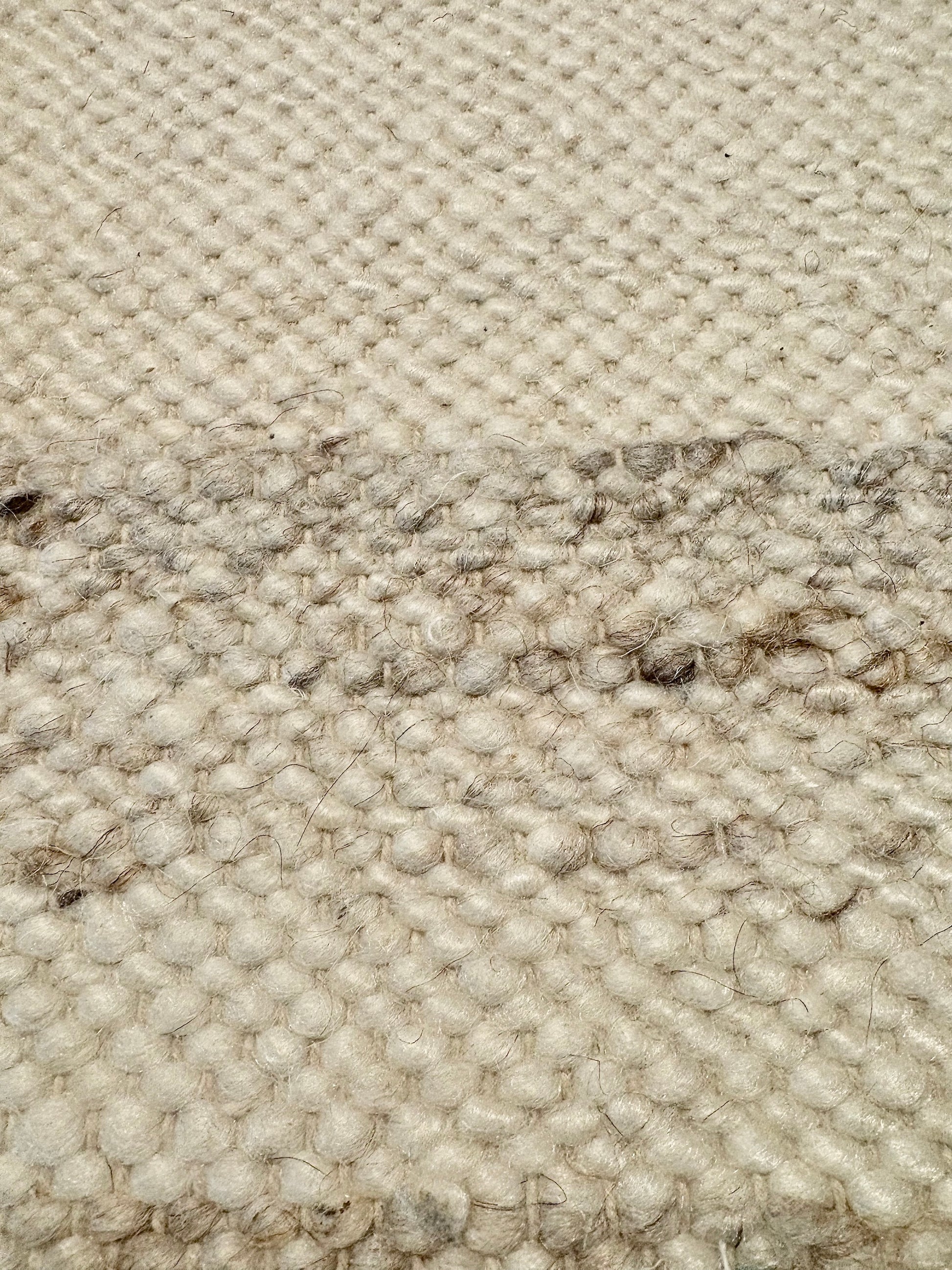 Harmony White Rug – hand-woven blend of wool and viscose in soft natural tones, featuring a textured finish that’s both elegant and durable. Colour White with black and brown fleck. 4 sizes. Close.