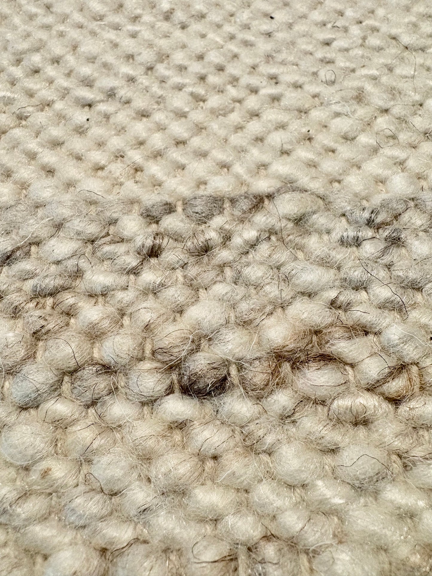 Harmony White Rug – hand-woven blend of wool and viscose in soft natural tones, featuring a textured finish that’s both elegant and durable. Colour White with black and brown fleck. 4 sizes. Super Close.