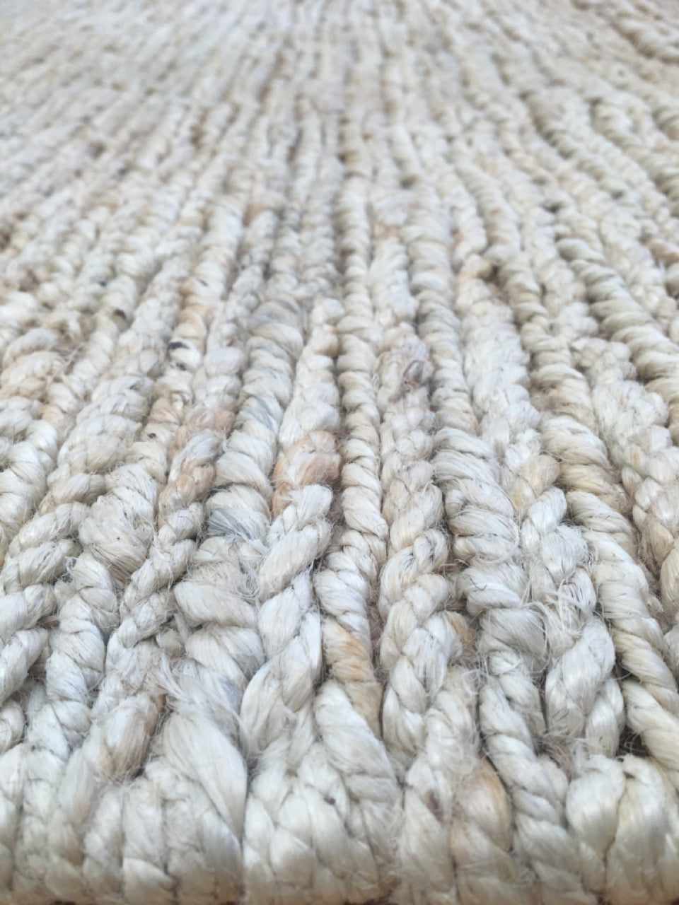 The Hemp Round - Bleach, hand-woven rug. Made in India, it features a round shape in two sizes, 160 and 190 Diameter. Colour, White/beige. Angle.