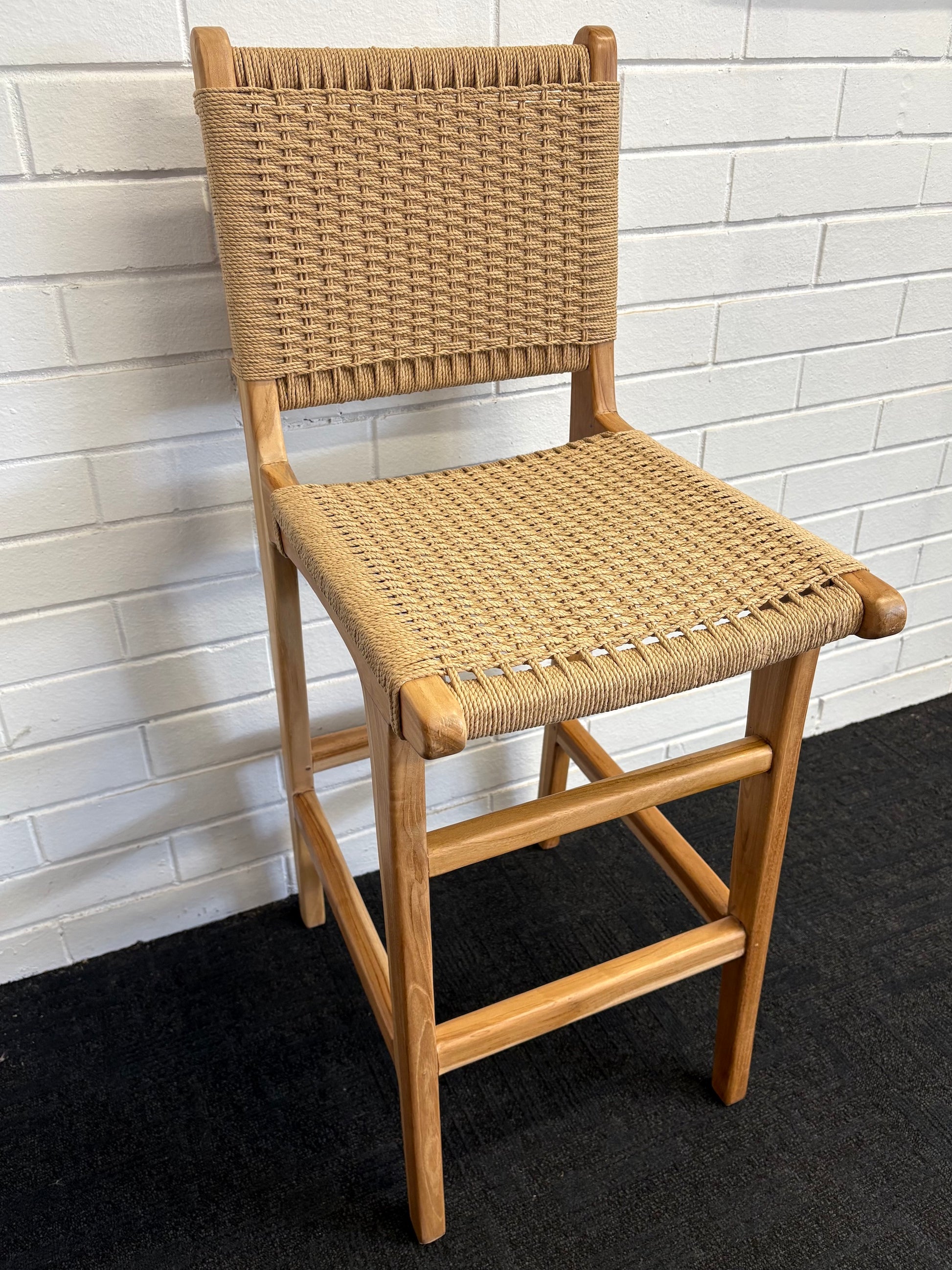 The Hudson with Back Barstool boasts a coastal contemporary feel. Crafted from sustainable solid teak and featuring a luxurious rope seat. Colour natural. Measures 400 Wide x 560 Depth x 1050 Back Height x 680 seat height. Angle.