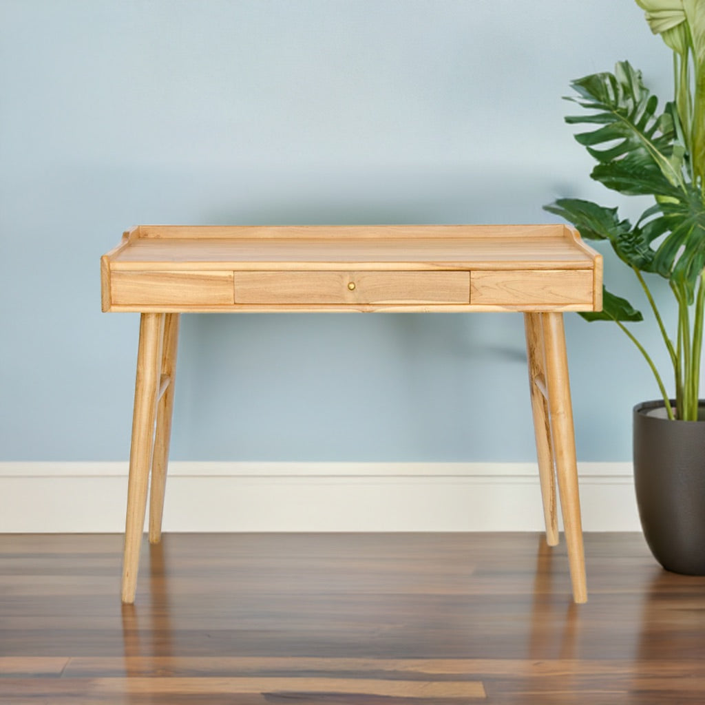 The Huron Desk - a beautifully crafted piece made from teak and supported by sleek, sturdy legs. Featuring 1 Drawer. Measures 1006 Length x 600 Depth x 750 Height. Colour Natural. Life.